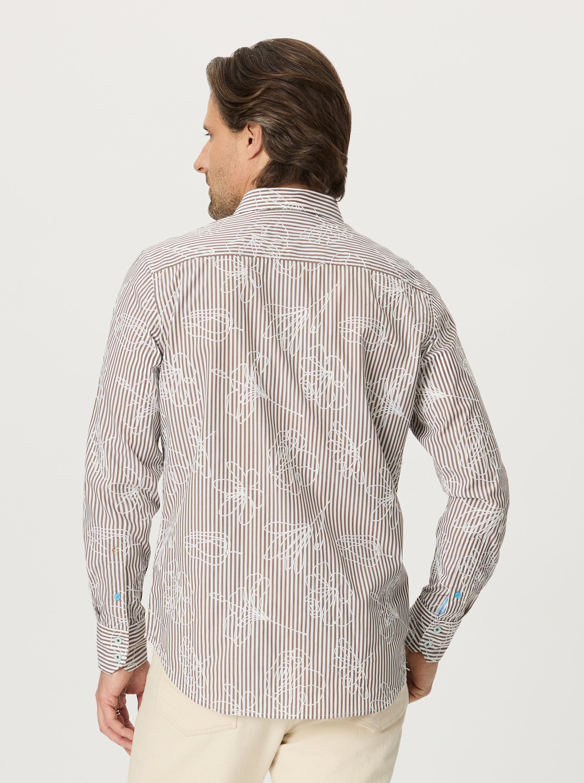 Man wearing a patterned shirt on a white background