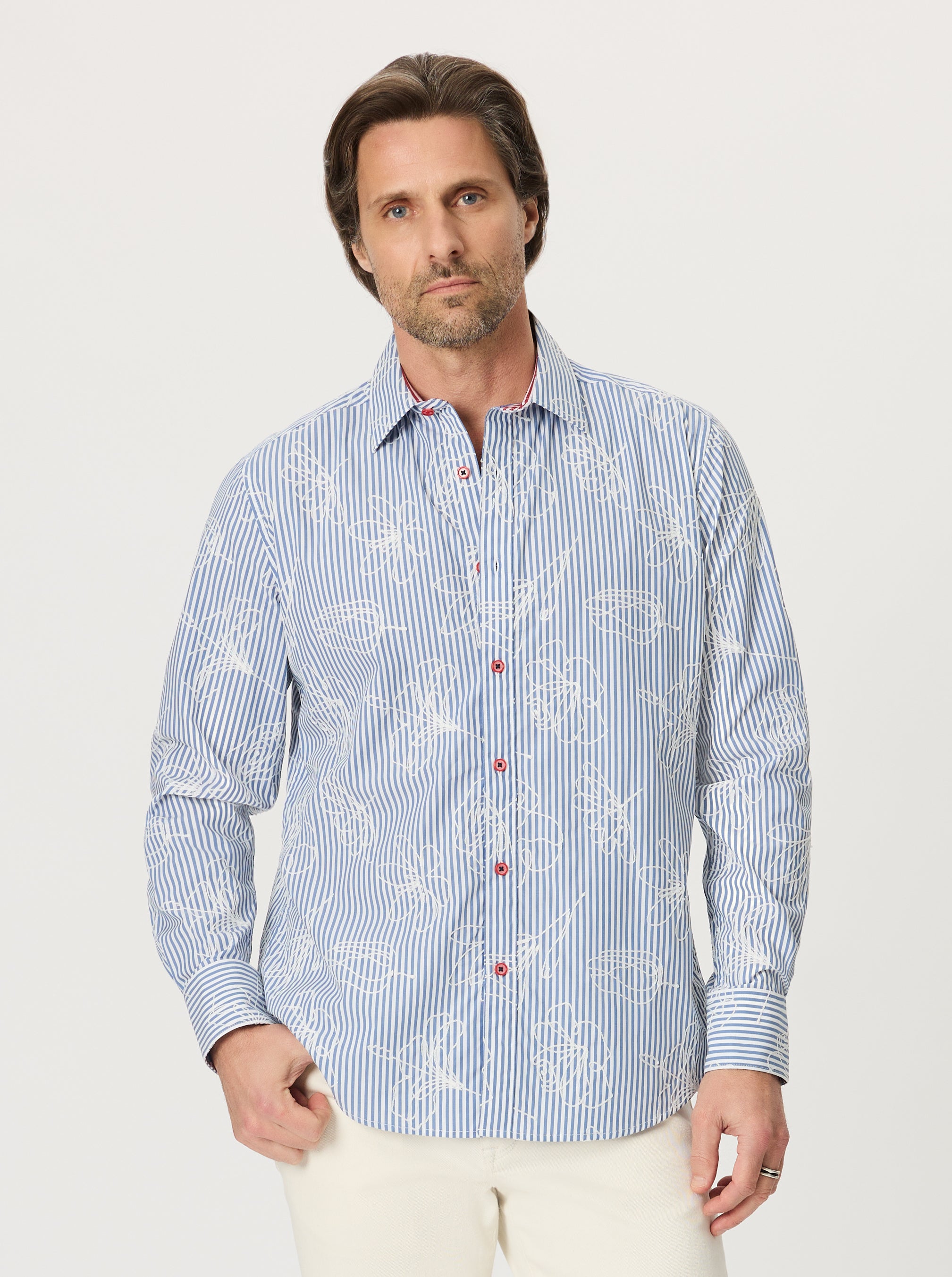 Man wearing a blue and white patterned shirt on a light gray background