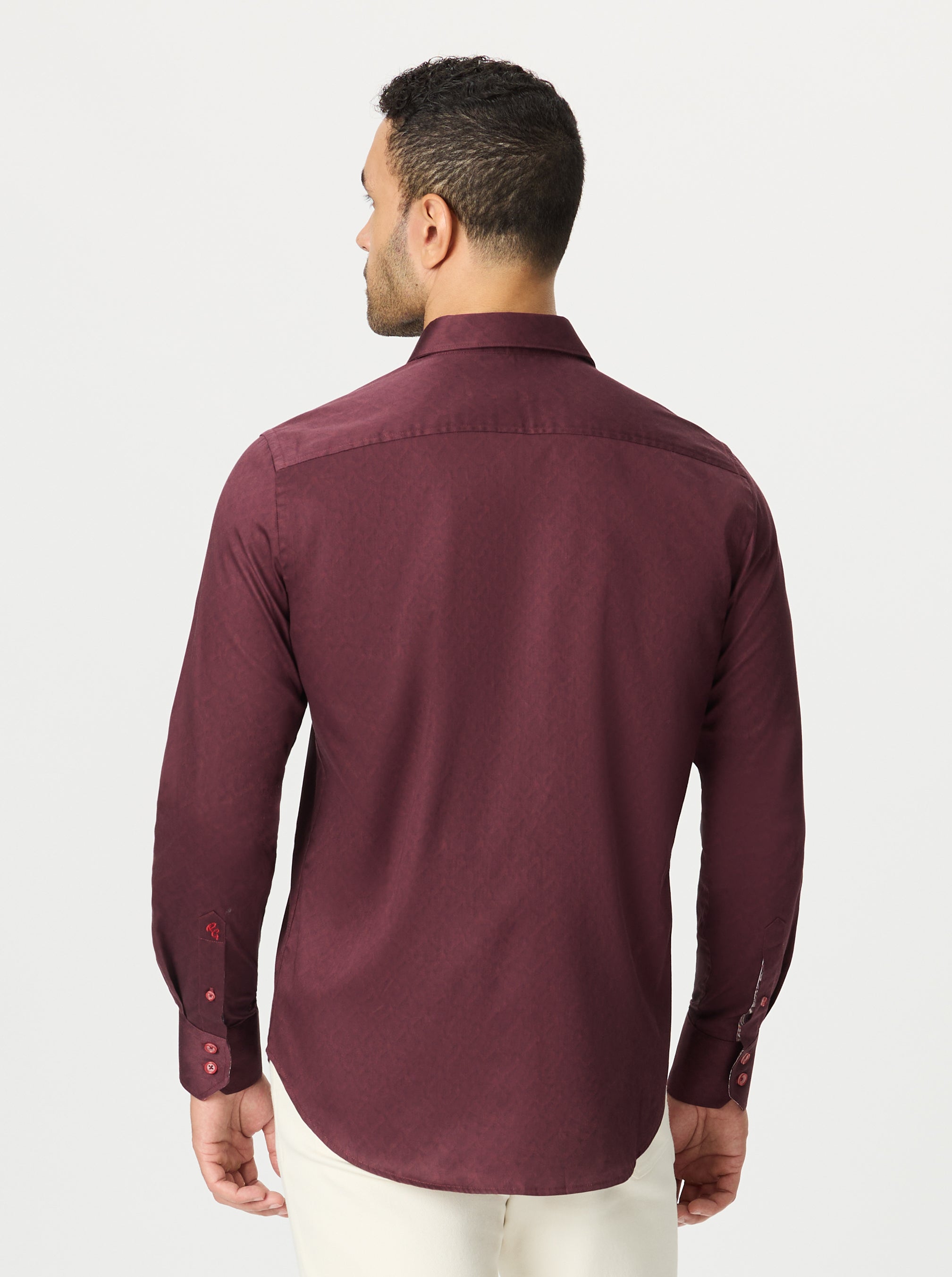 Man wearing a burgundy long sleeve shirt on a white background