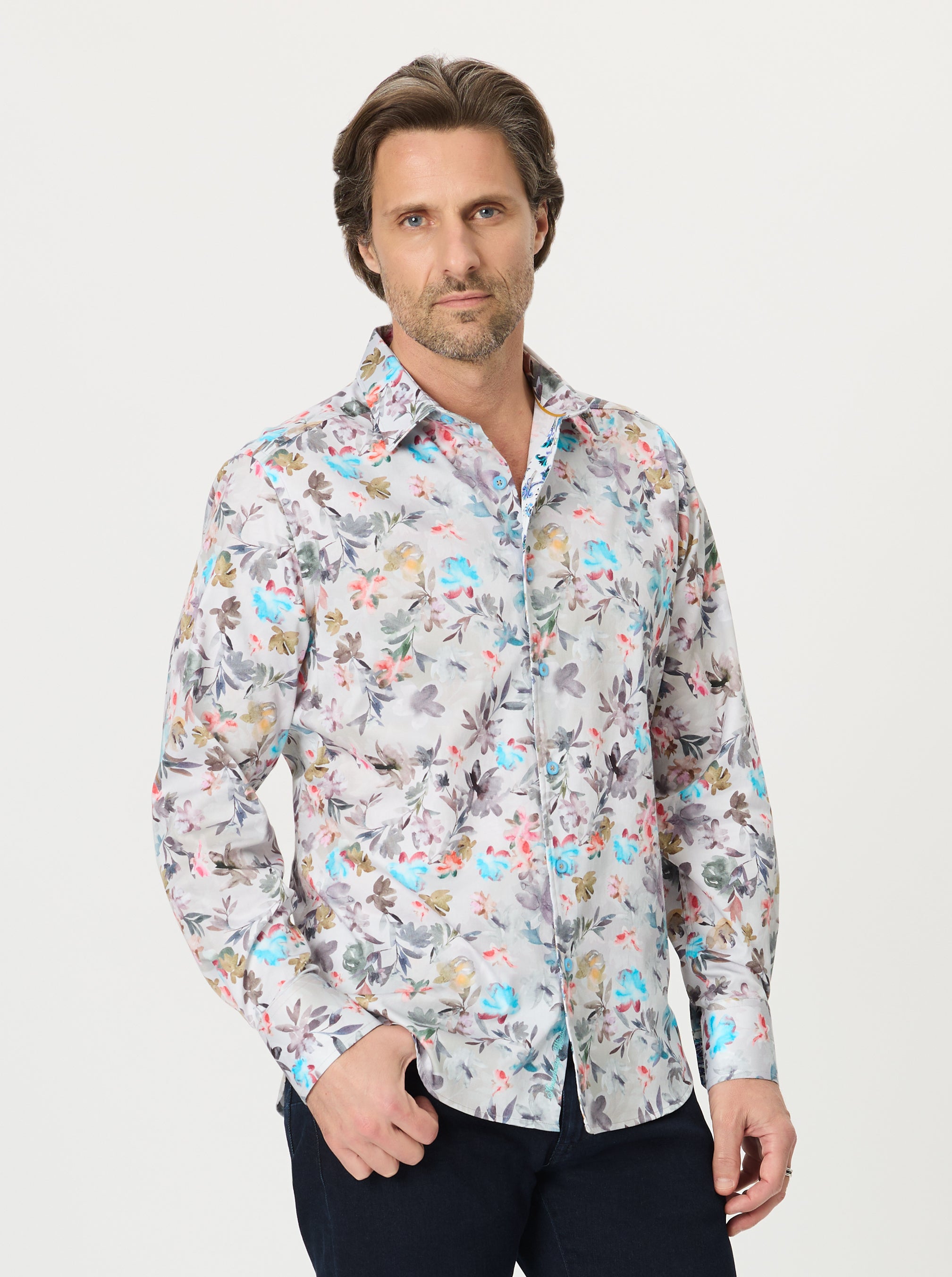 Man wearing a patterned shirt on a plain background