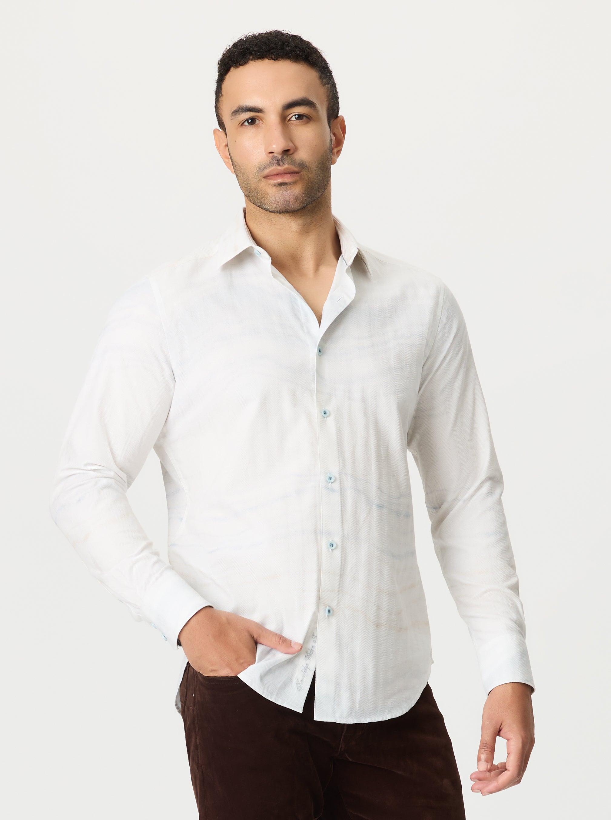 Man wearing a white dress shirt against a plain background