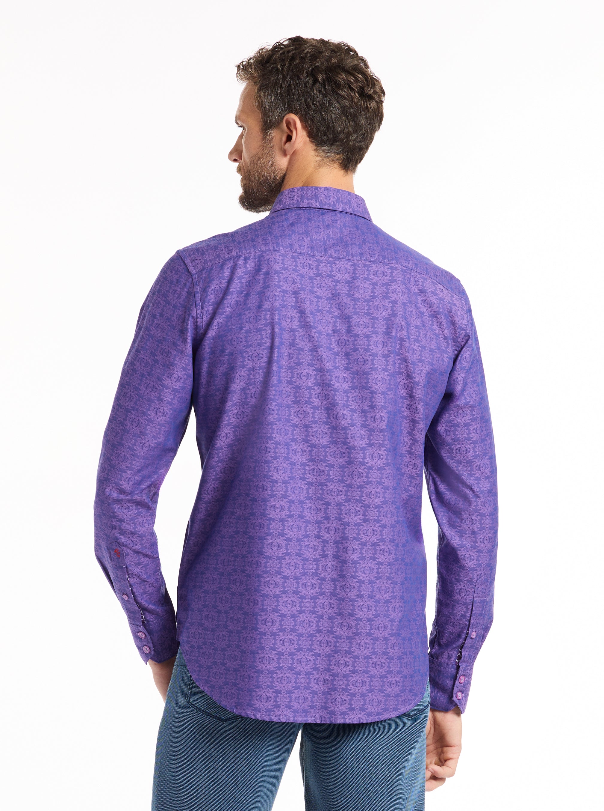 Man wearing a purple patterned shirt on a white background
