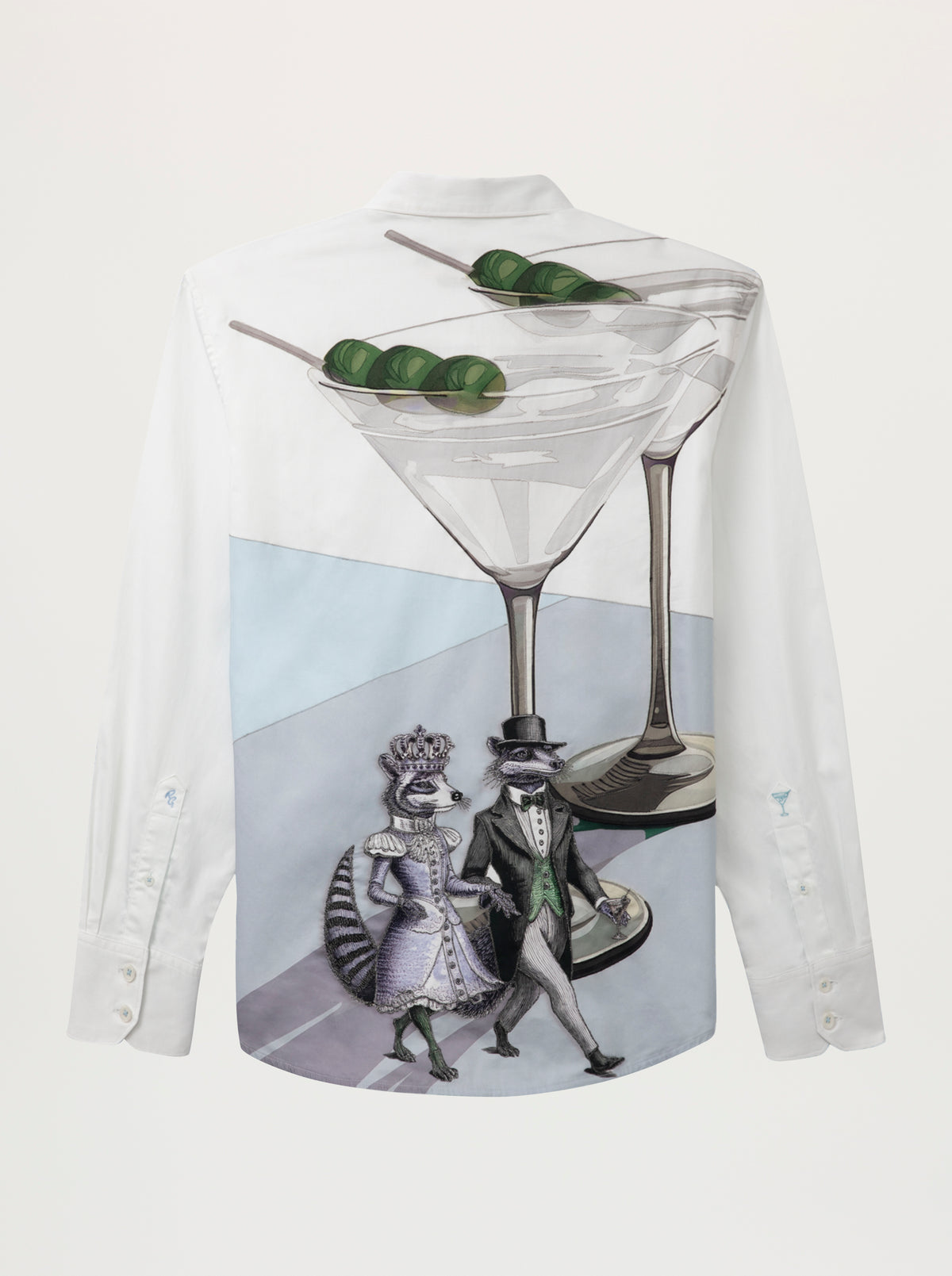 A white long-sleeve button-up shirt with a large graphic print on the front. The print features a large martini glass with olives on a skewer, with two stylized animals dressed in formal wear walking underneath, set against a light gray and blue background.