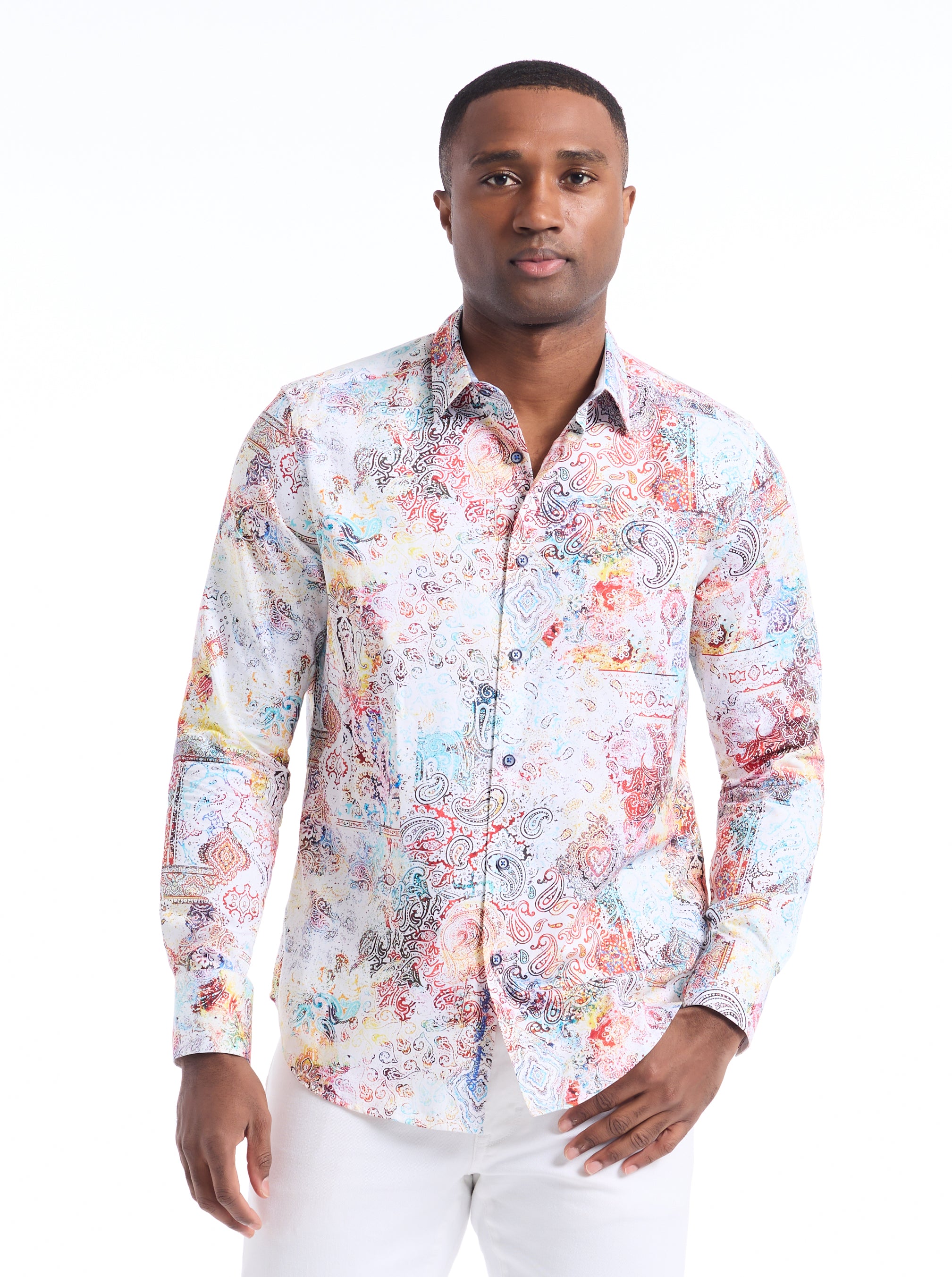 Man wearing a colorful patterned shirt on a white background