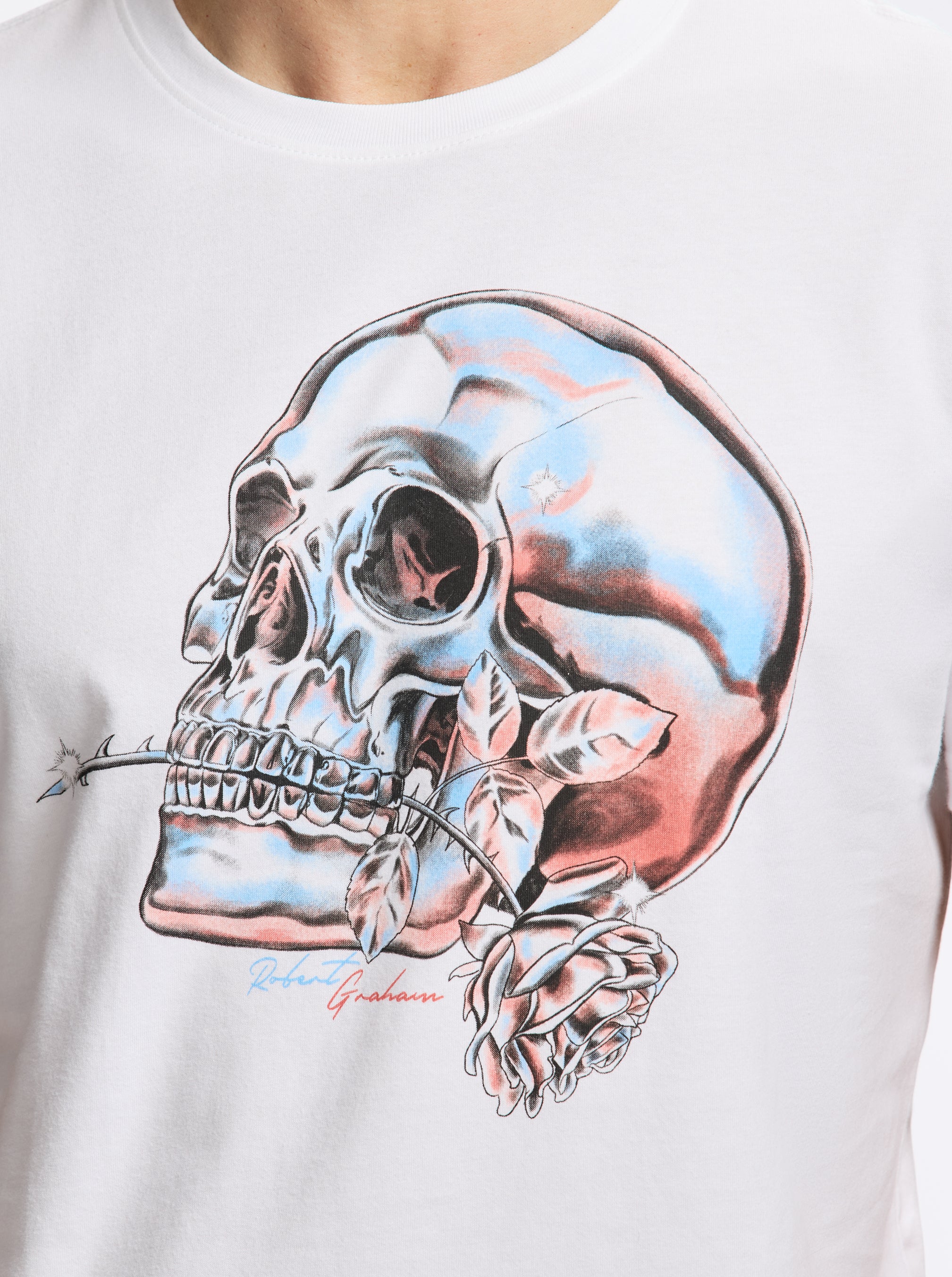 White t-shirt with a colorful skull with a rose design on a plain background