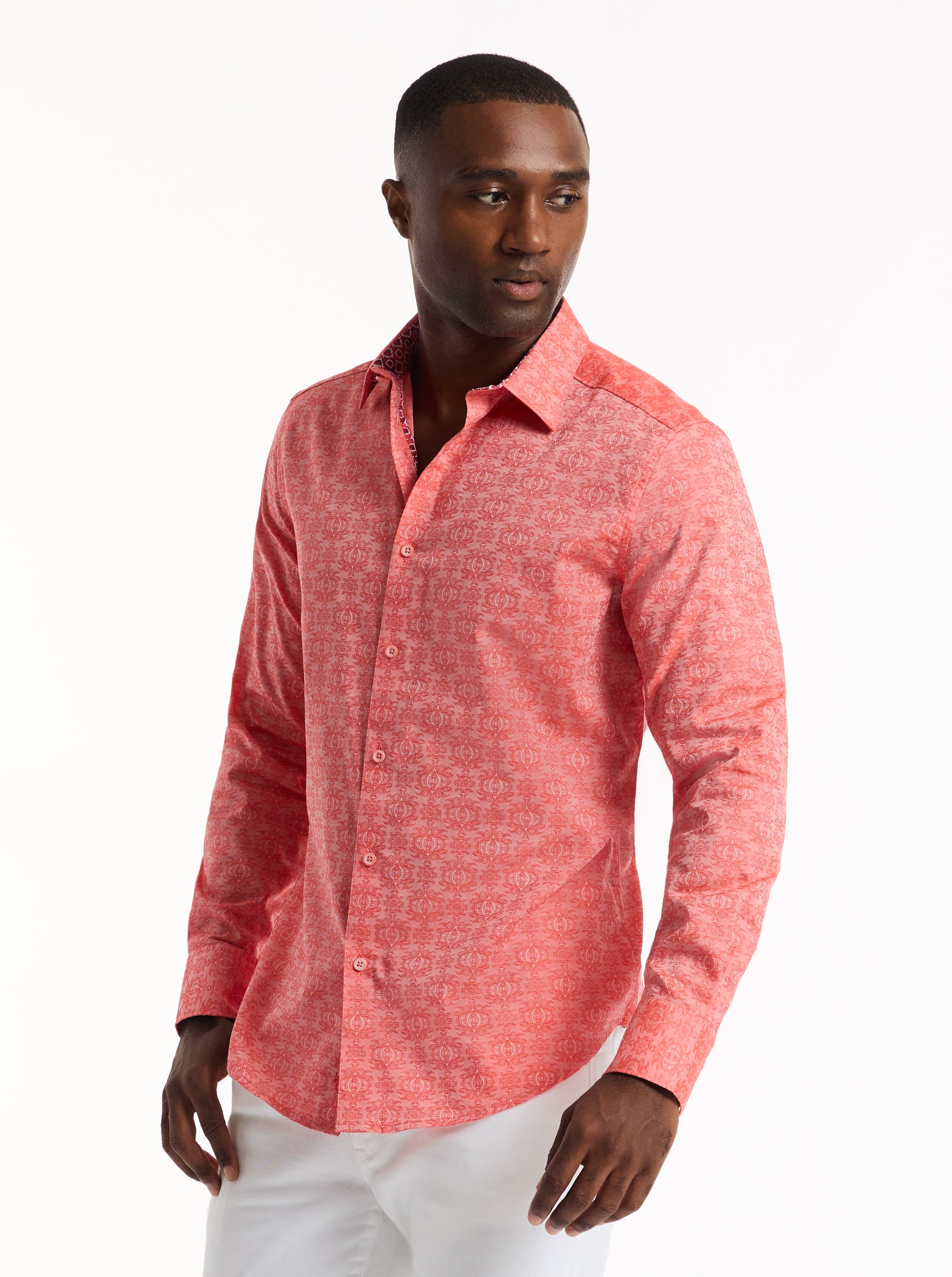 Man wearing a red patterned shirt on a white background