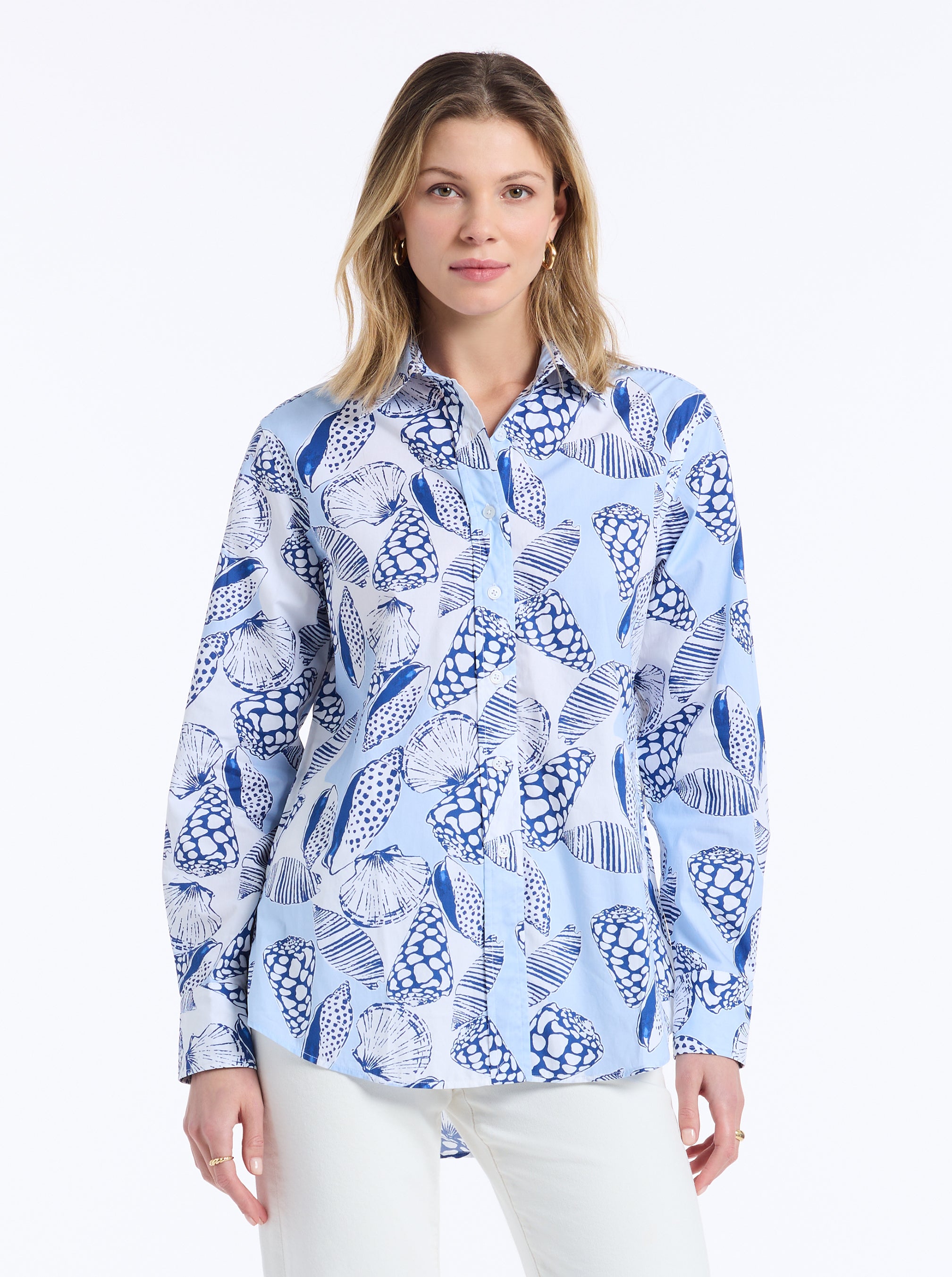 Woman wearing a blue and white patterned shirt on a white background