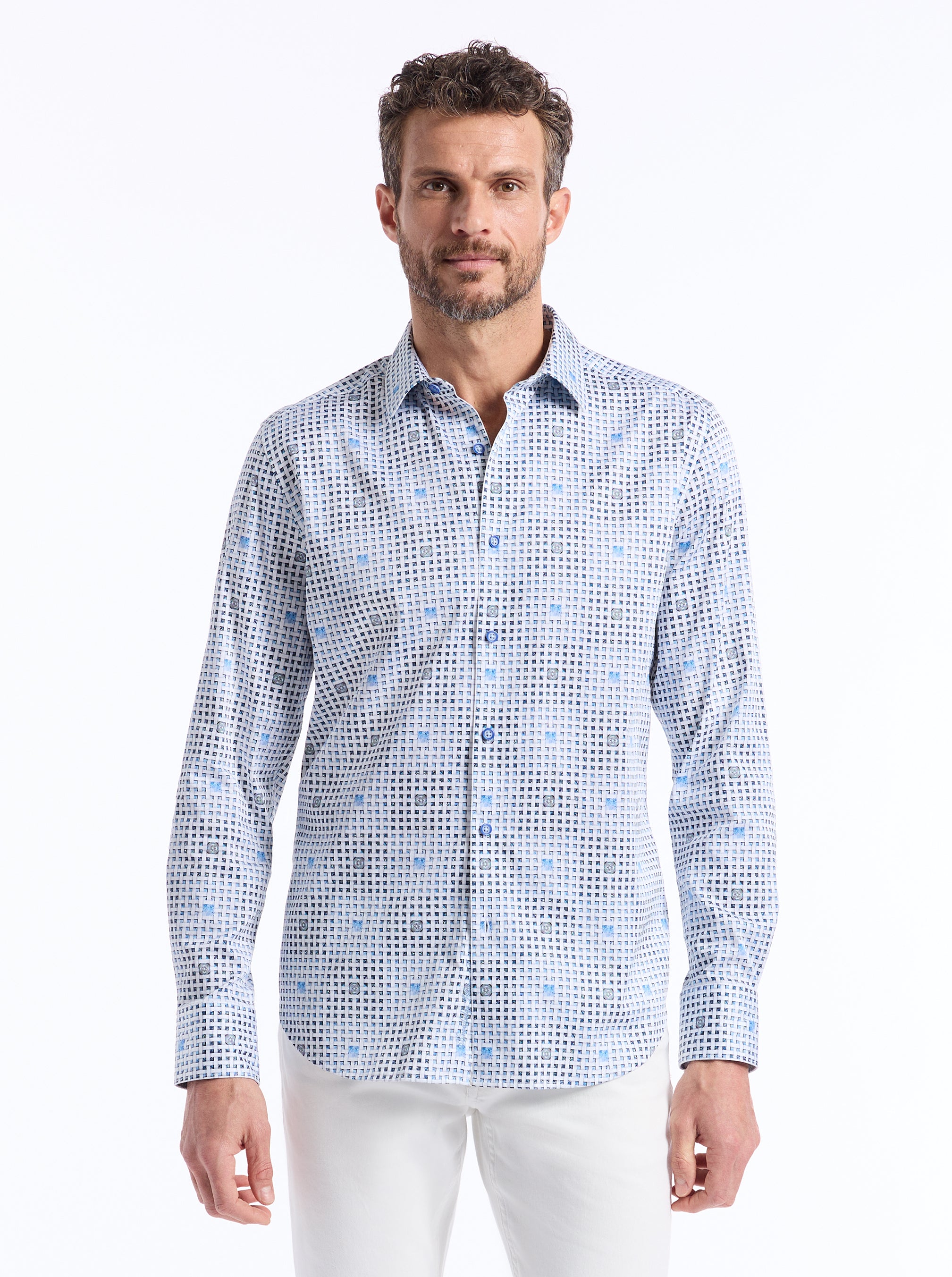 Man wearing a patterned shirt on a white background