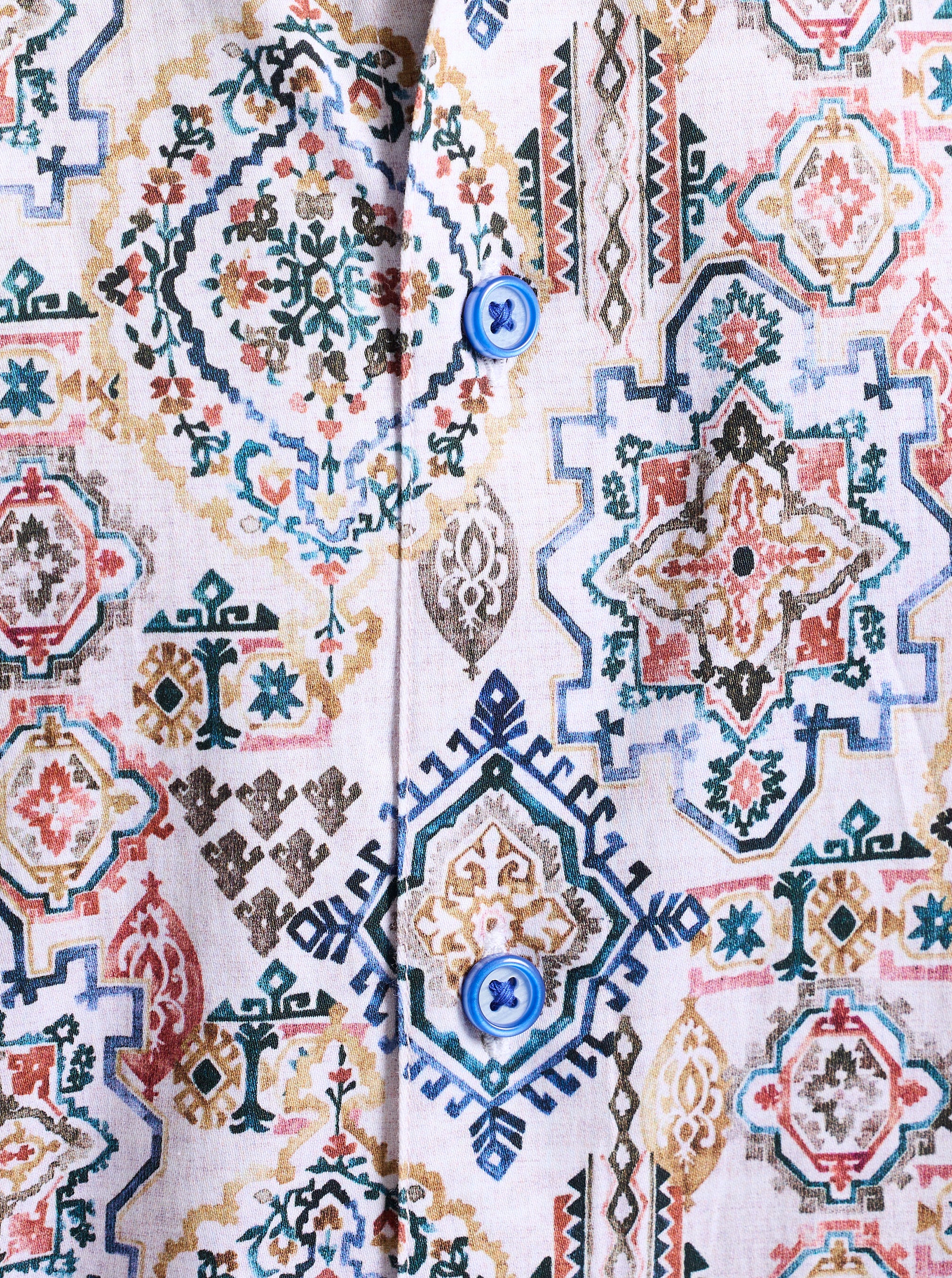 Close-up of a patterned fabric with geometric and floral designs.