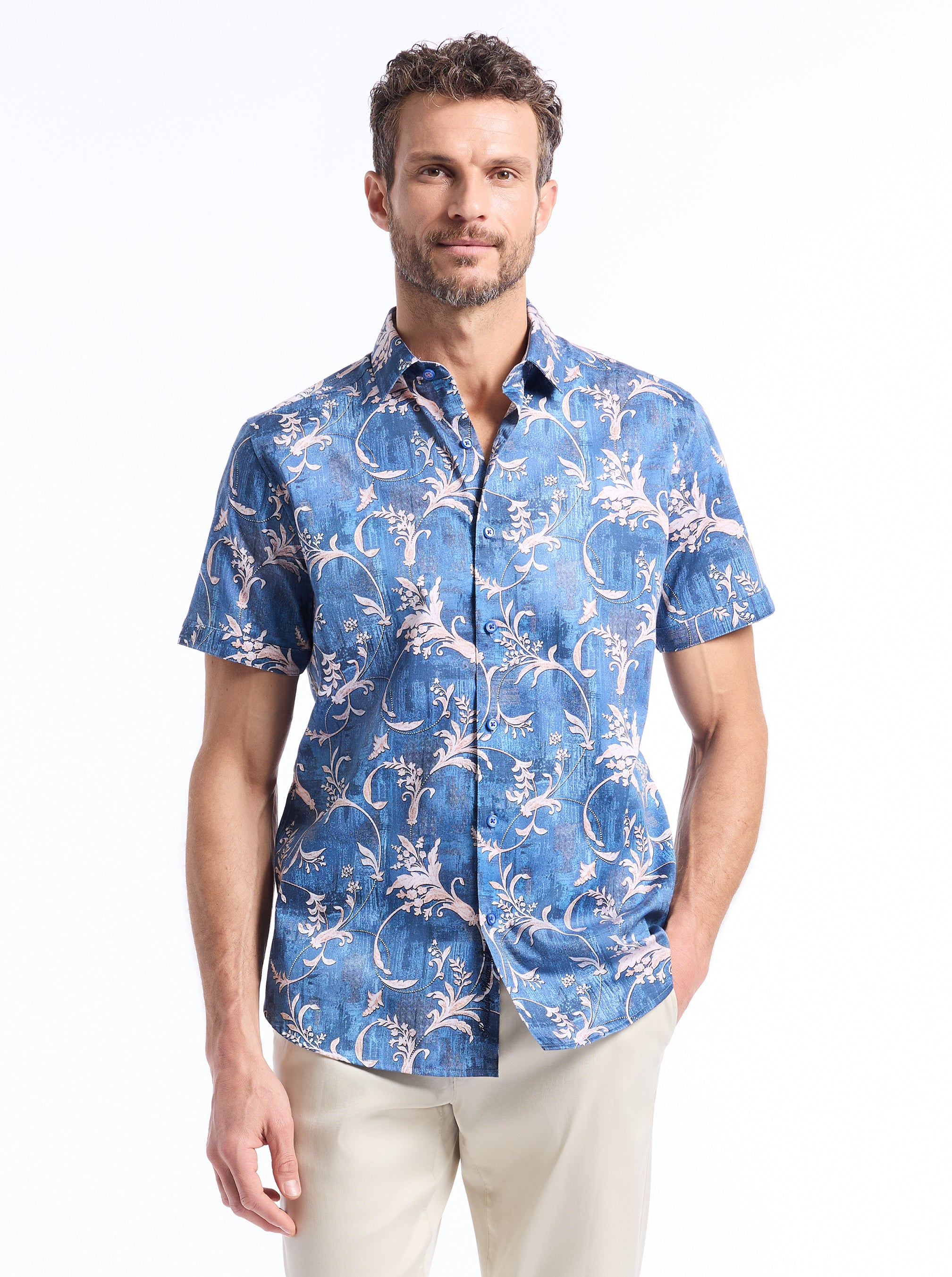 Man wearing a blue patterned shirt on a white background