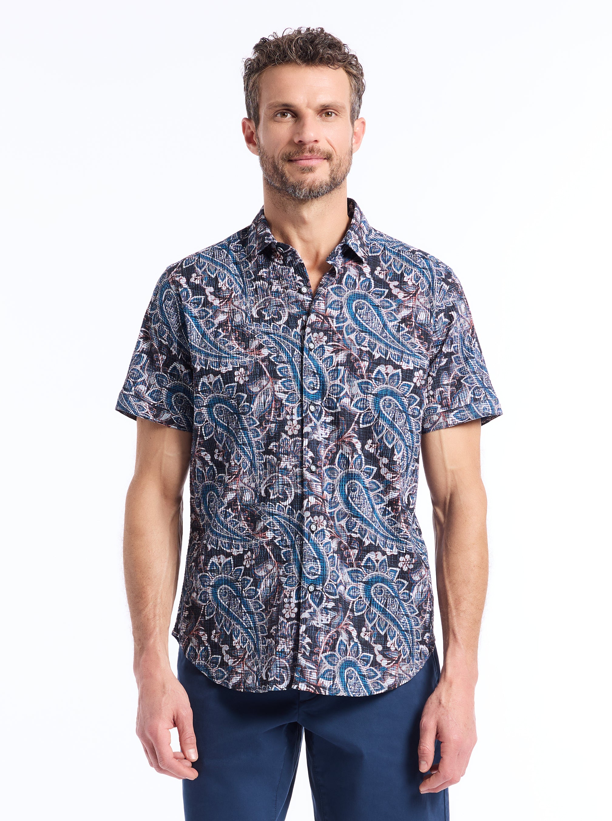 Man wearing a seersucker paisley patterned shirt on a white background