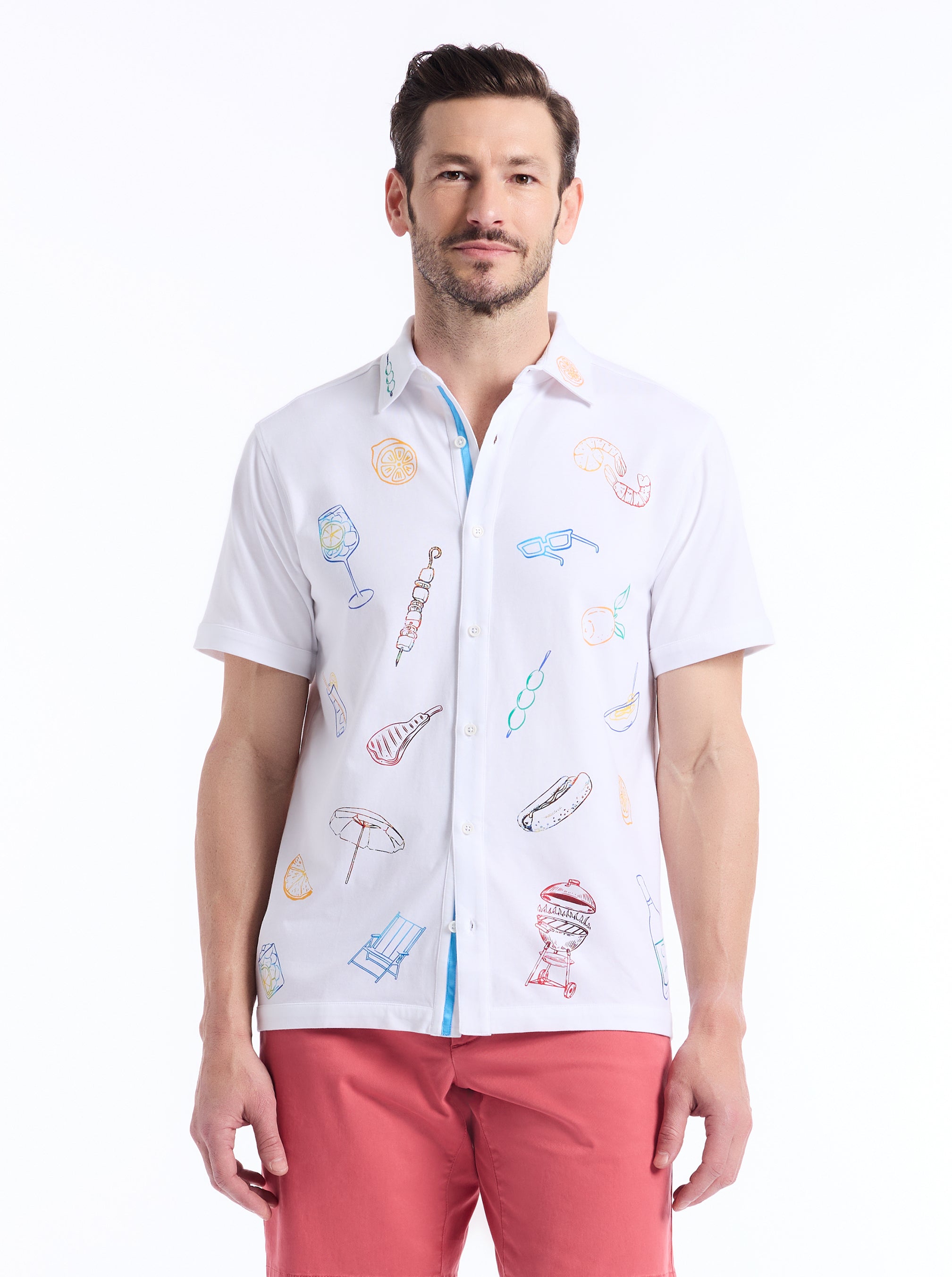 Man wearing a white shirt with colorful graphics and pink pants on a white background