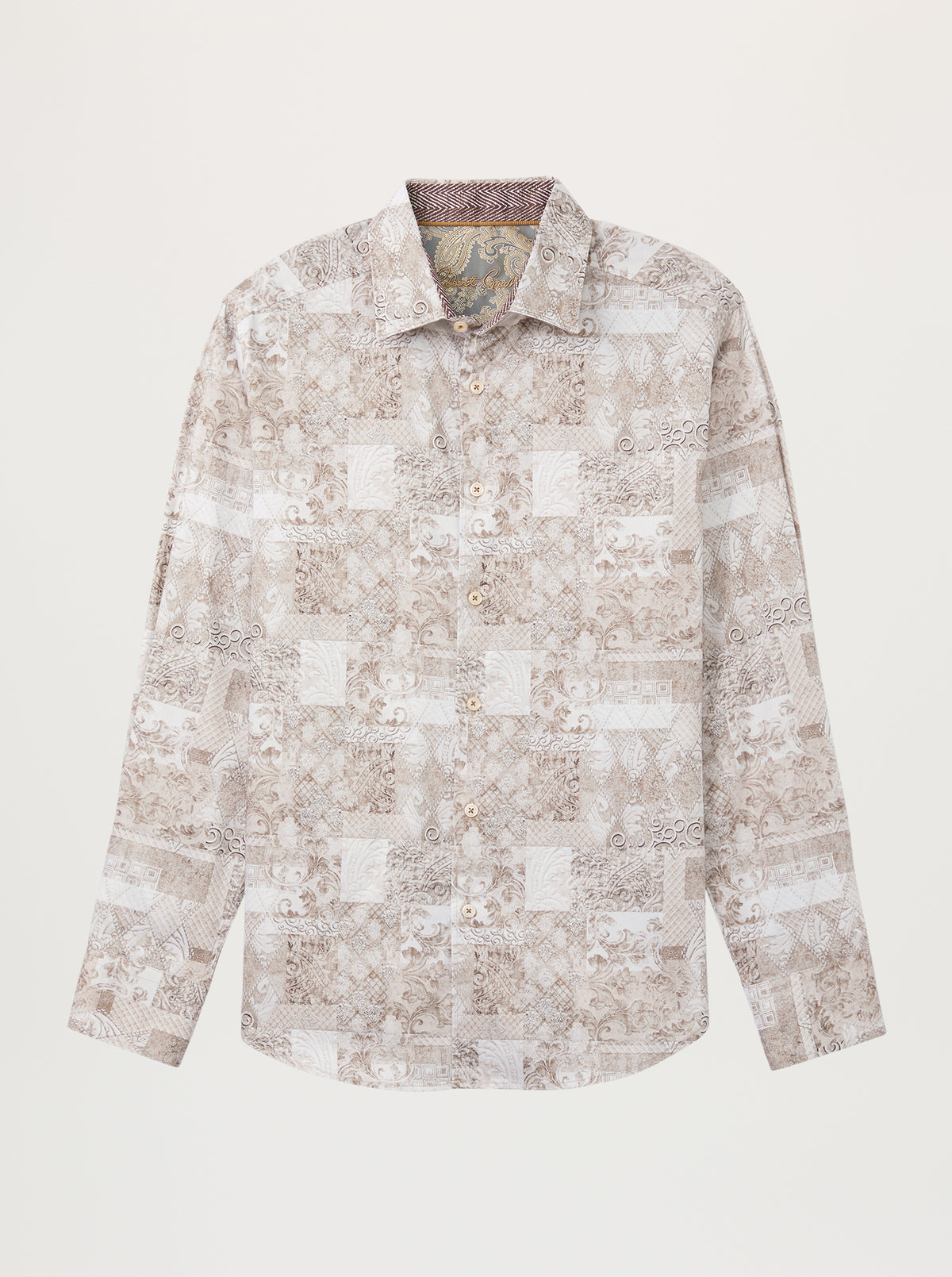 A long-sleeve button-up shirt with a beige and white patchwork-style abstract pattern, displayed flat against a light cream background.