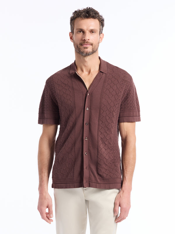 Man wearing a brown textured knit shirt on a white background