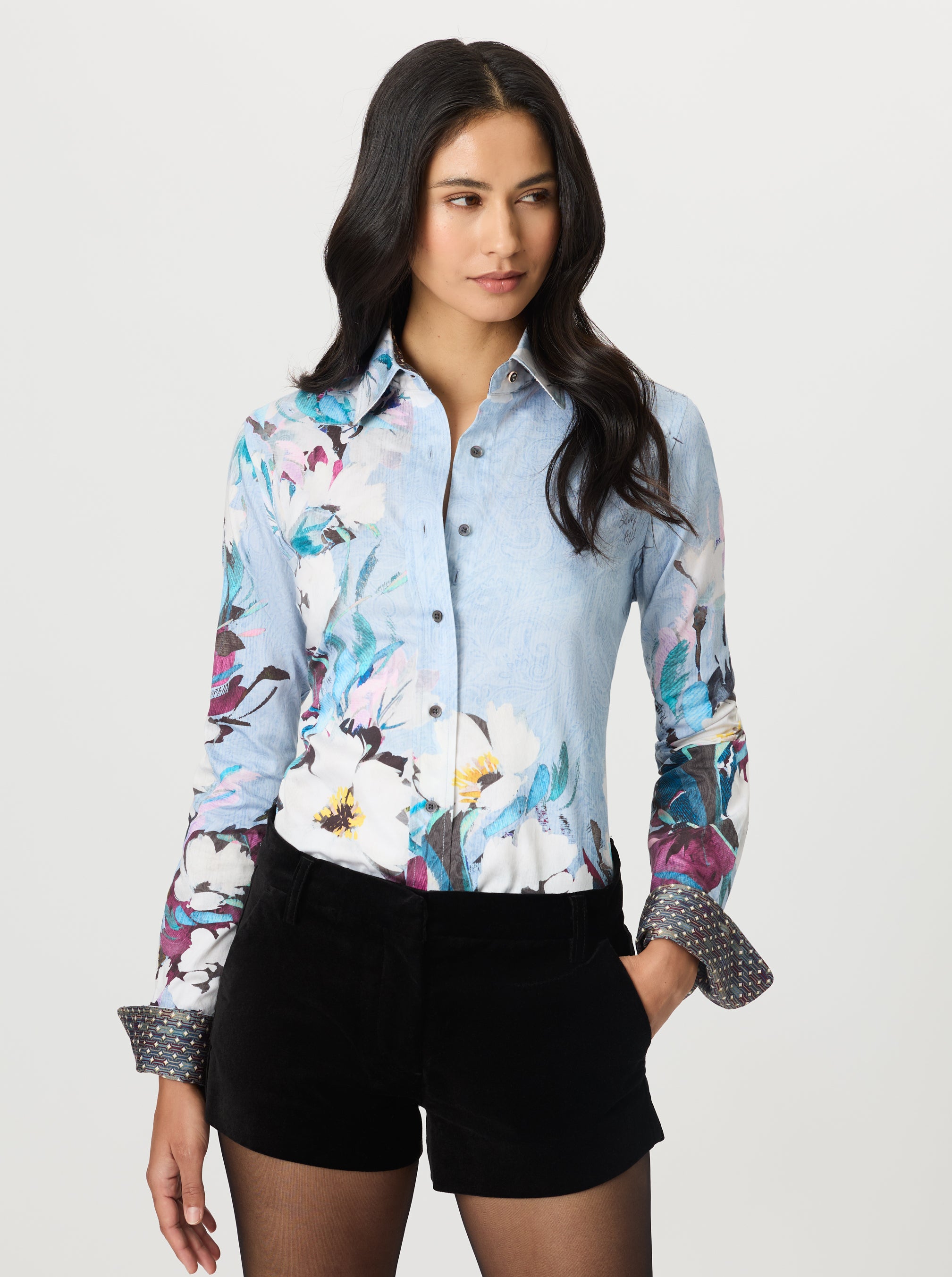 Woman wearing a floral blouse with a white background