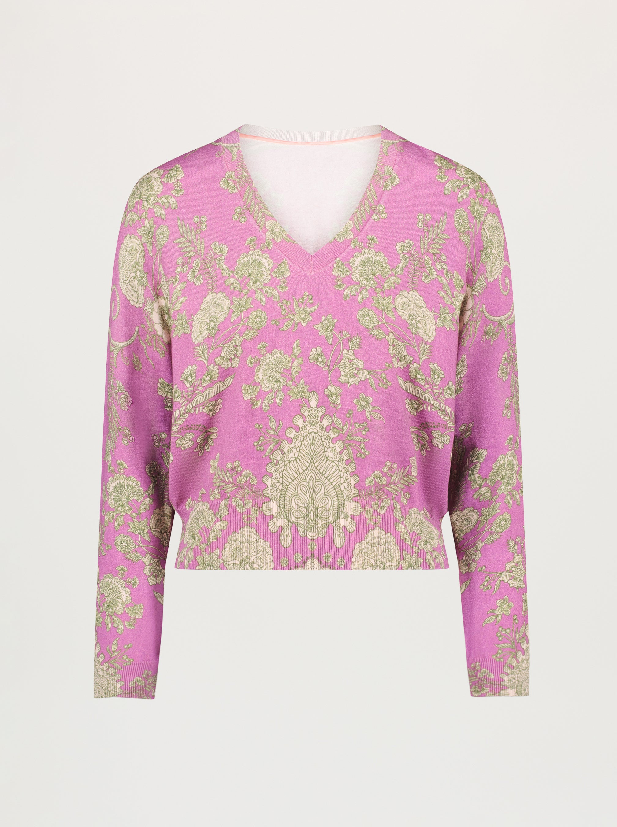 Pink sweater with tan floral and damask pattern on a plain background