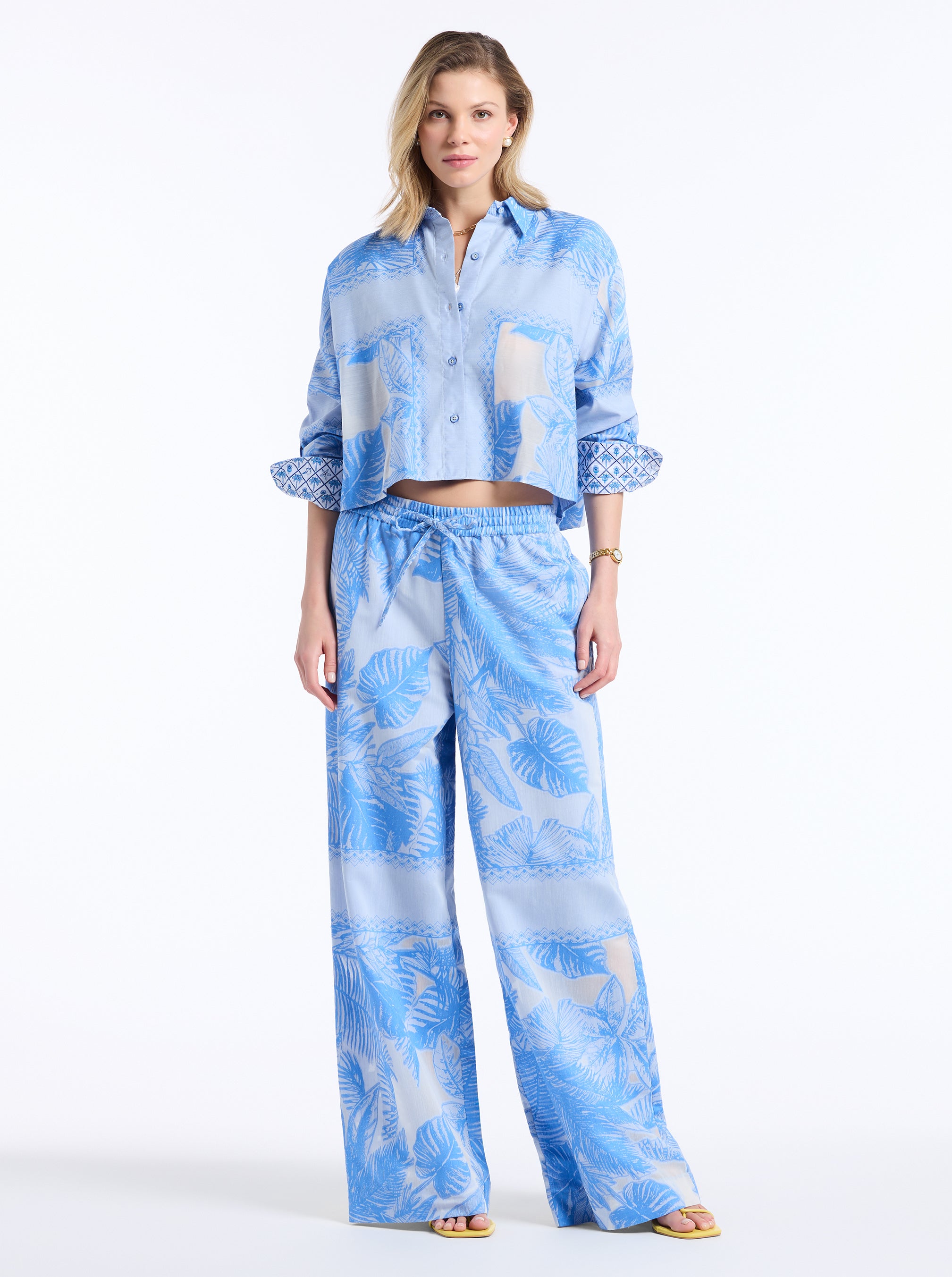 Woman wearing a blue matching outfit on a white background