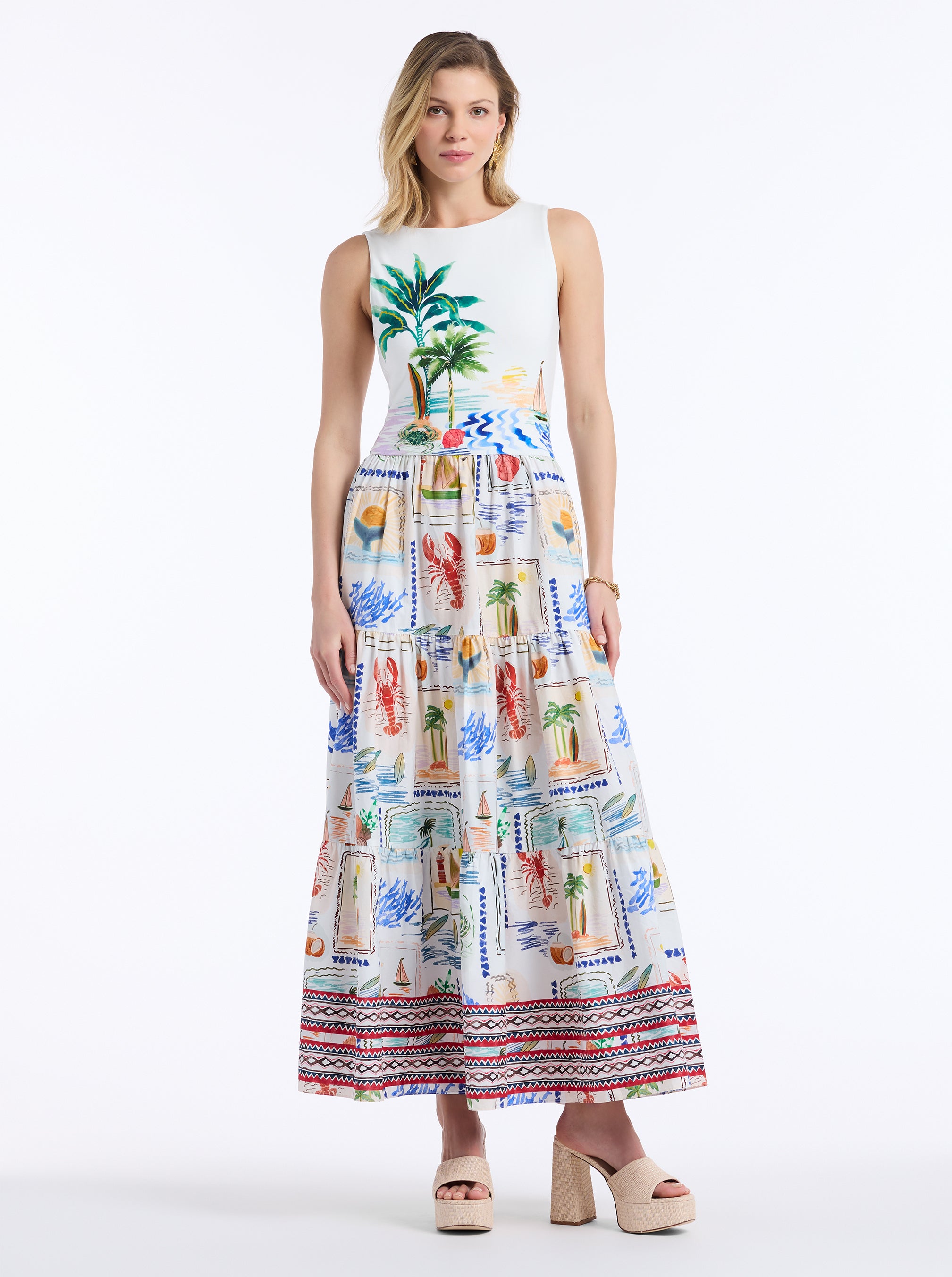 Woman wearing a sleeveless dress with a colorful tropical pattern on a white background