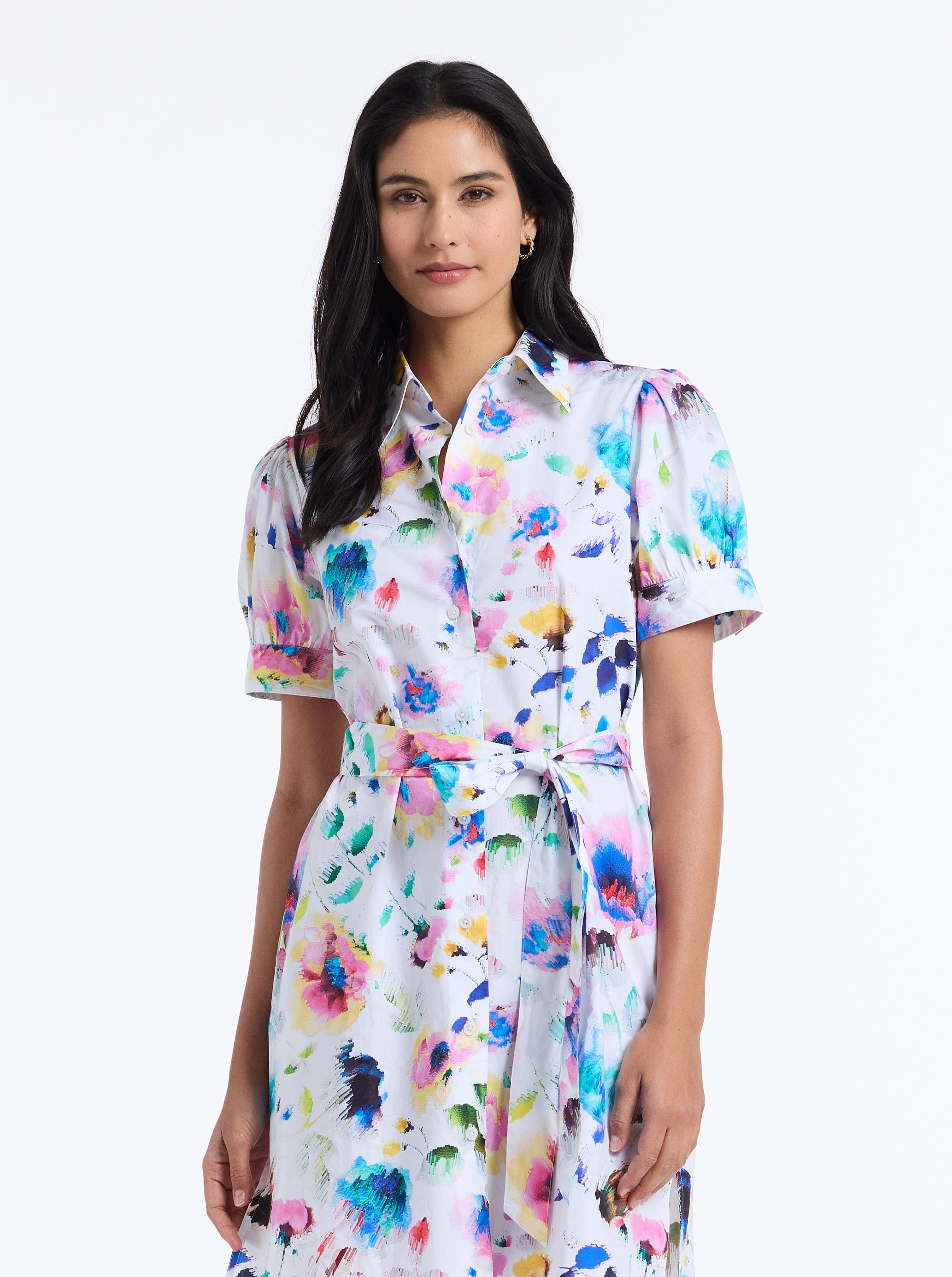 Woman wearing a colorful abstract dress on a white background
