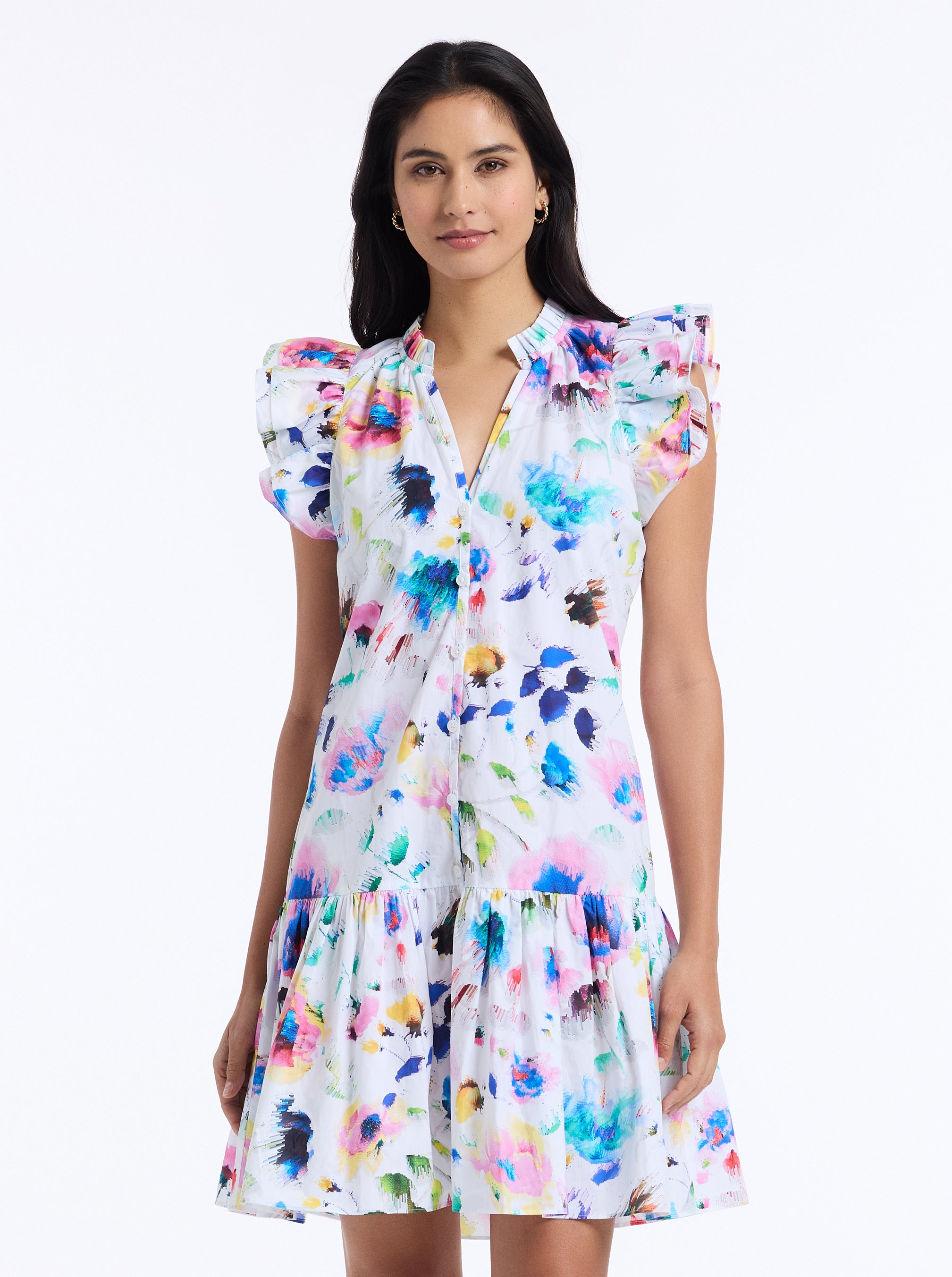Woman wearing a colorful abstract print dress on a white background