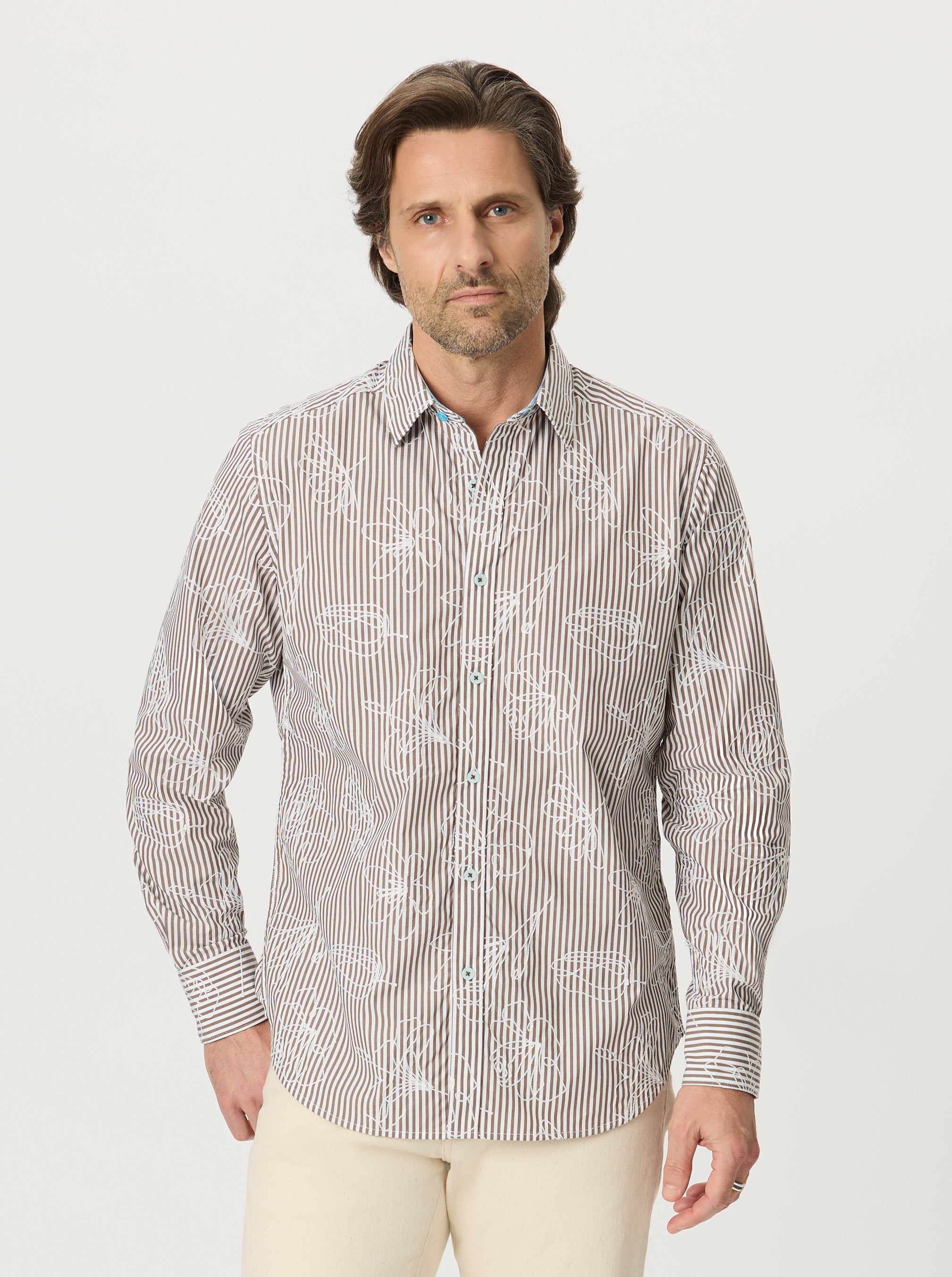 Man wearing a patterned shirt on a white background