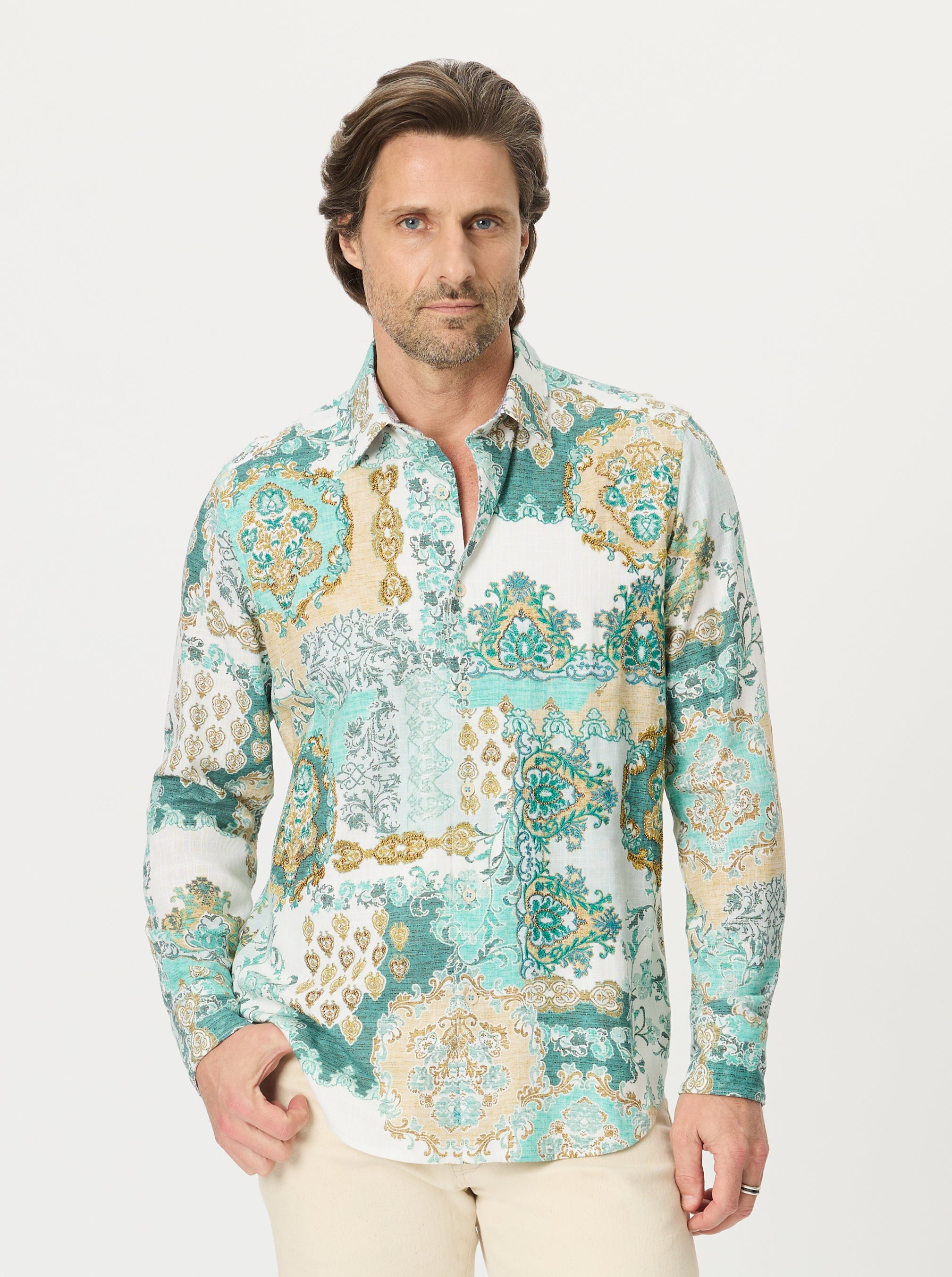 Man wearing a damask patterned shirt on a white background