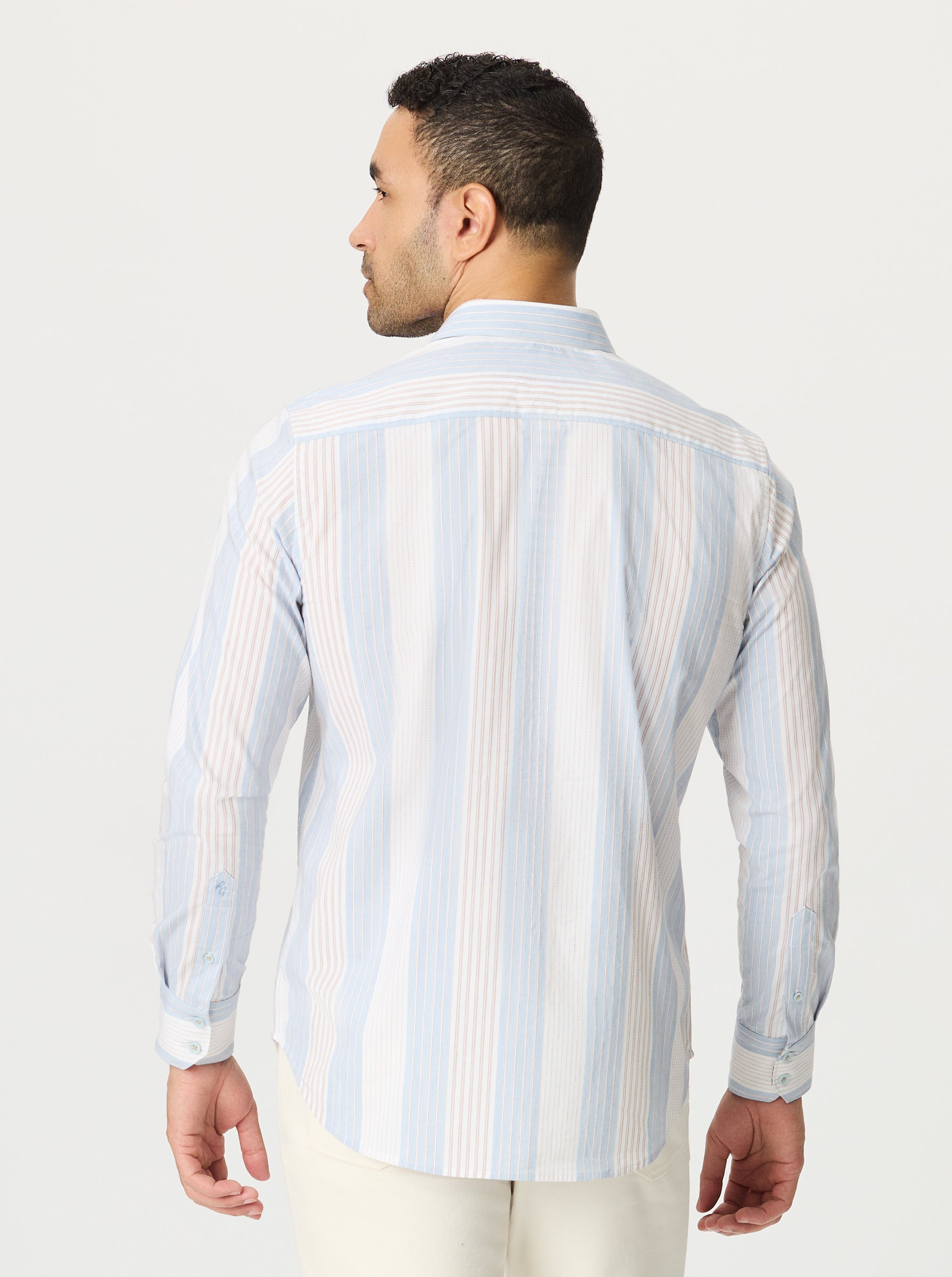 Man wearing a light blue and white striped shirt on a plain background