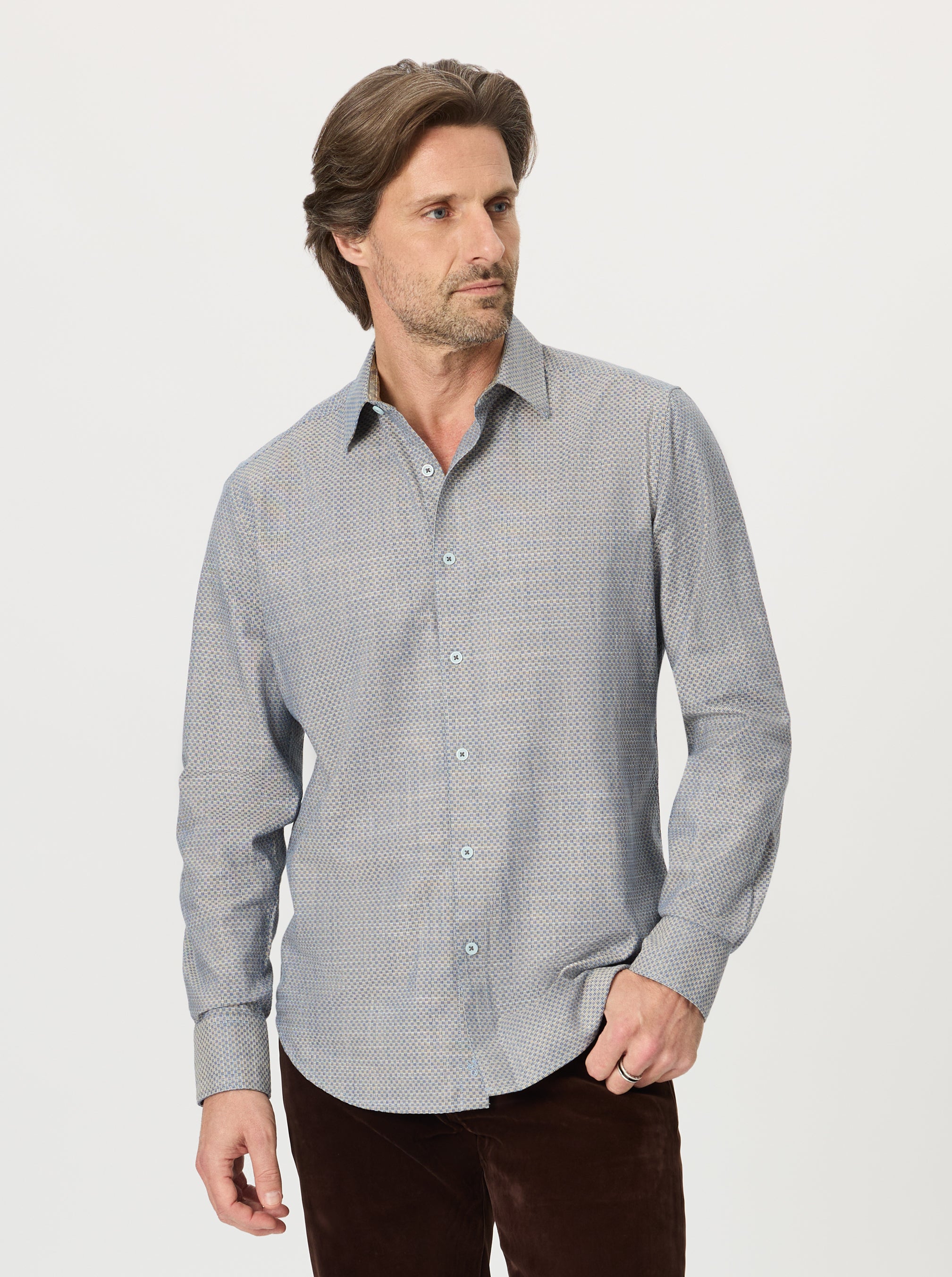 Man wearing a gray patterned shirt on a white background