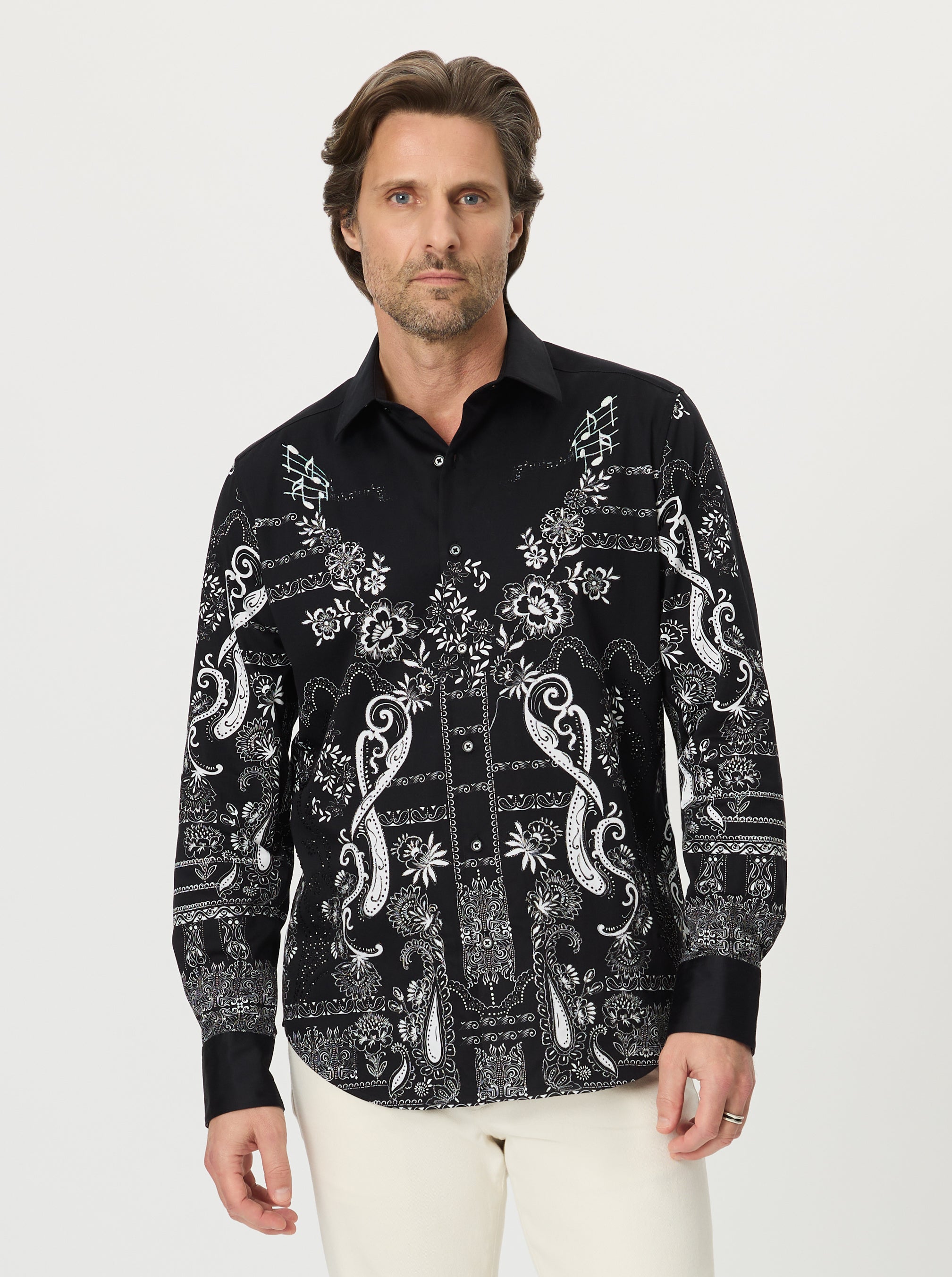 Man wearing a black patterned shirt on a white background