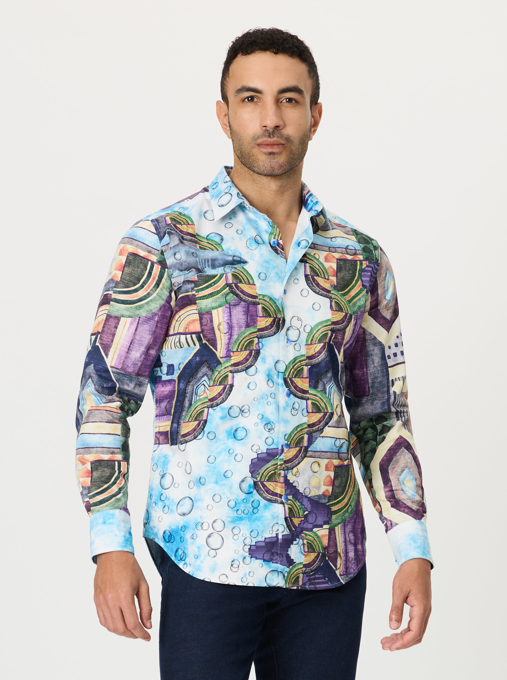 Man wearing a colorful patterned shirt on a white background
