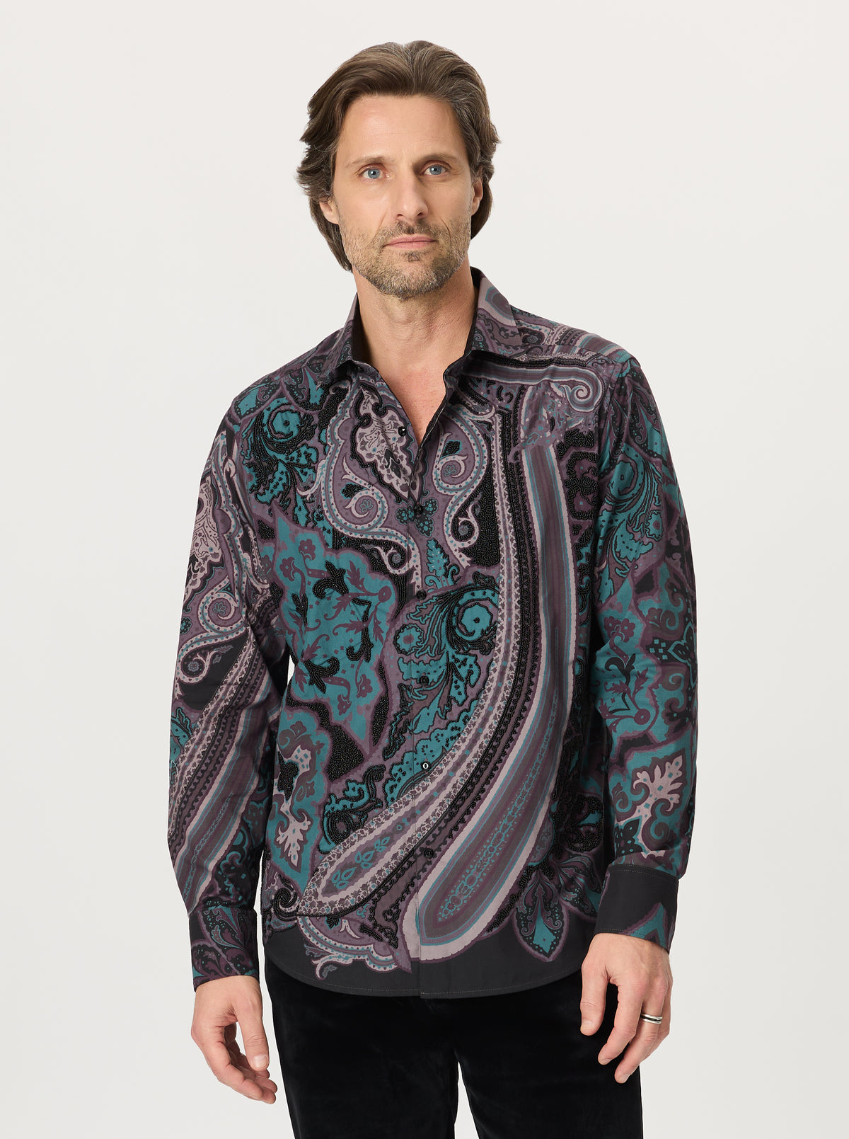 Man wearing a paisley patterned shirt on a white background