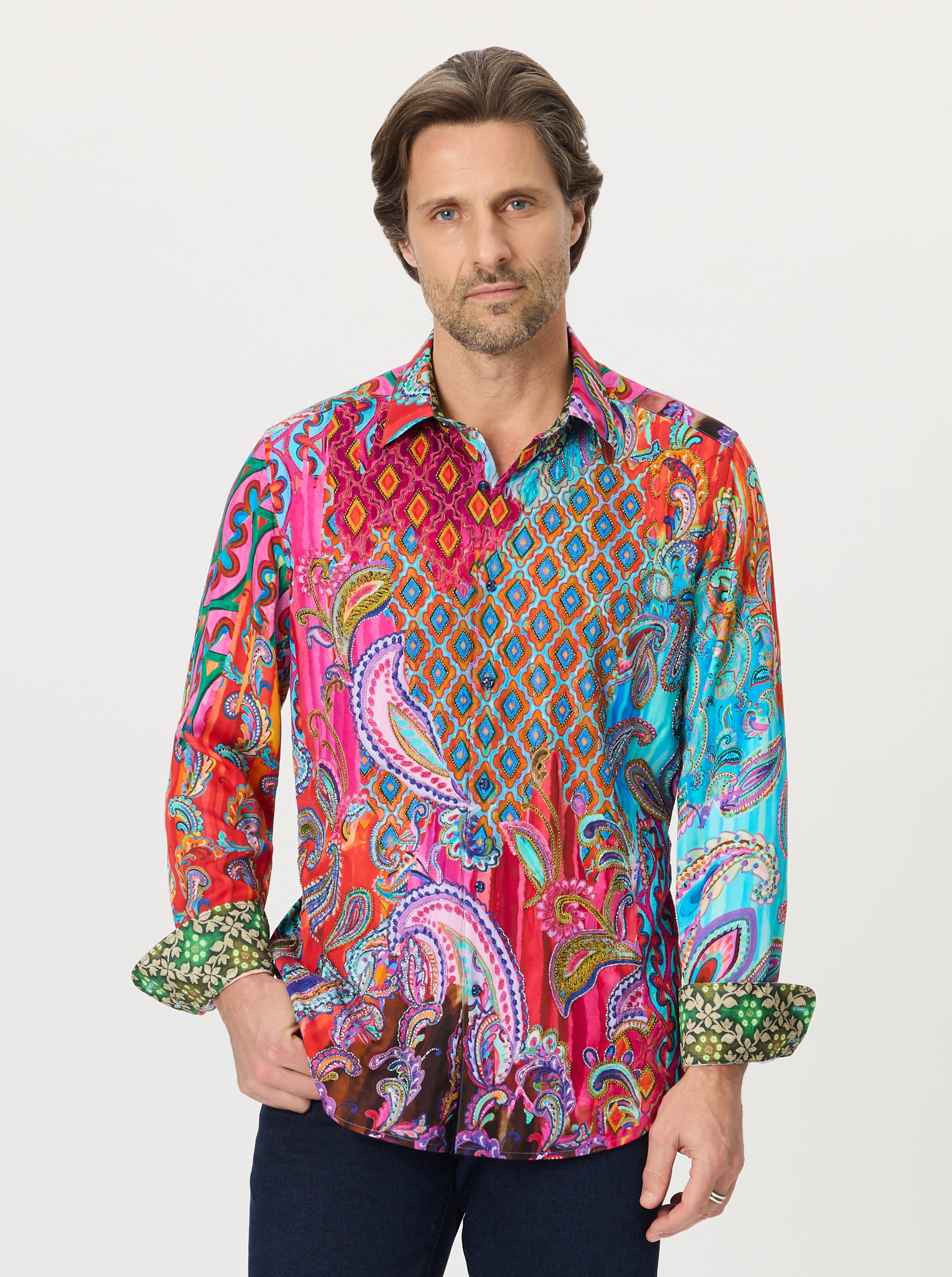 Man wearing a colorful paisley patterned shirt on a white background