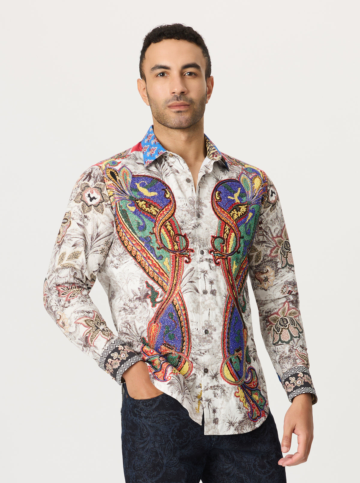 Man wearing a colorful patterned shirt on a white background
