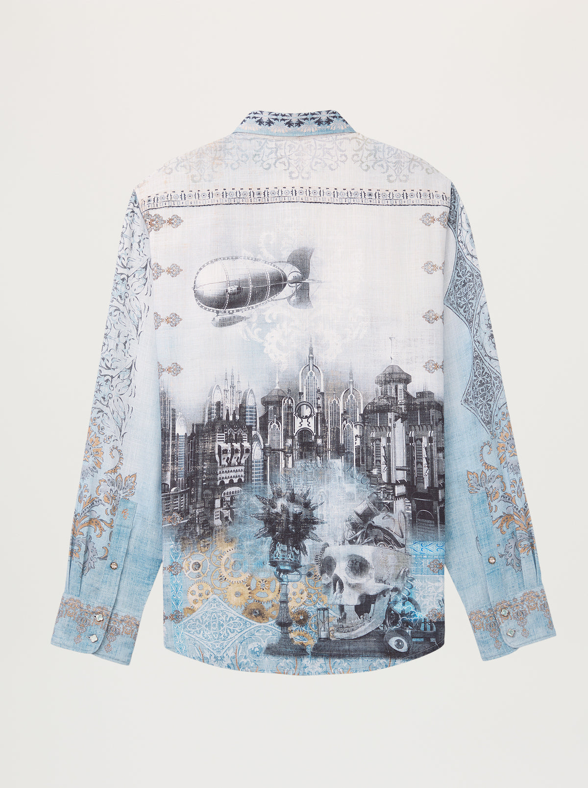 A long-sleeve button-up shirt shown from the back, featuring a detailed graphic print of a gothic cityscape with a skull, a blimp, and ornate light blue and gold patterns.