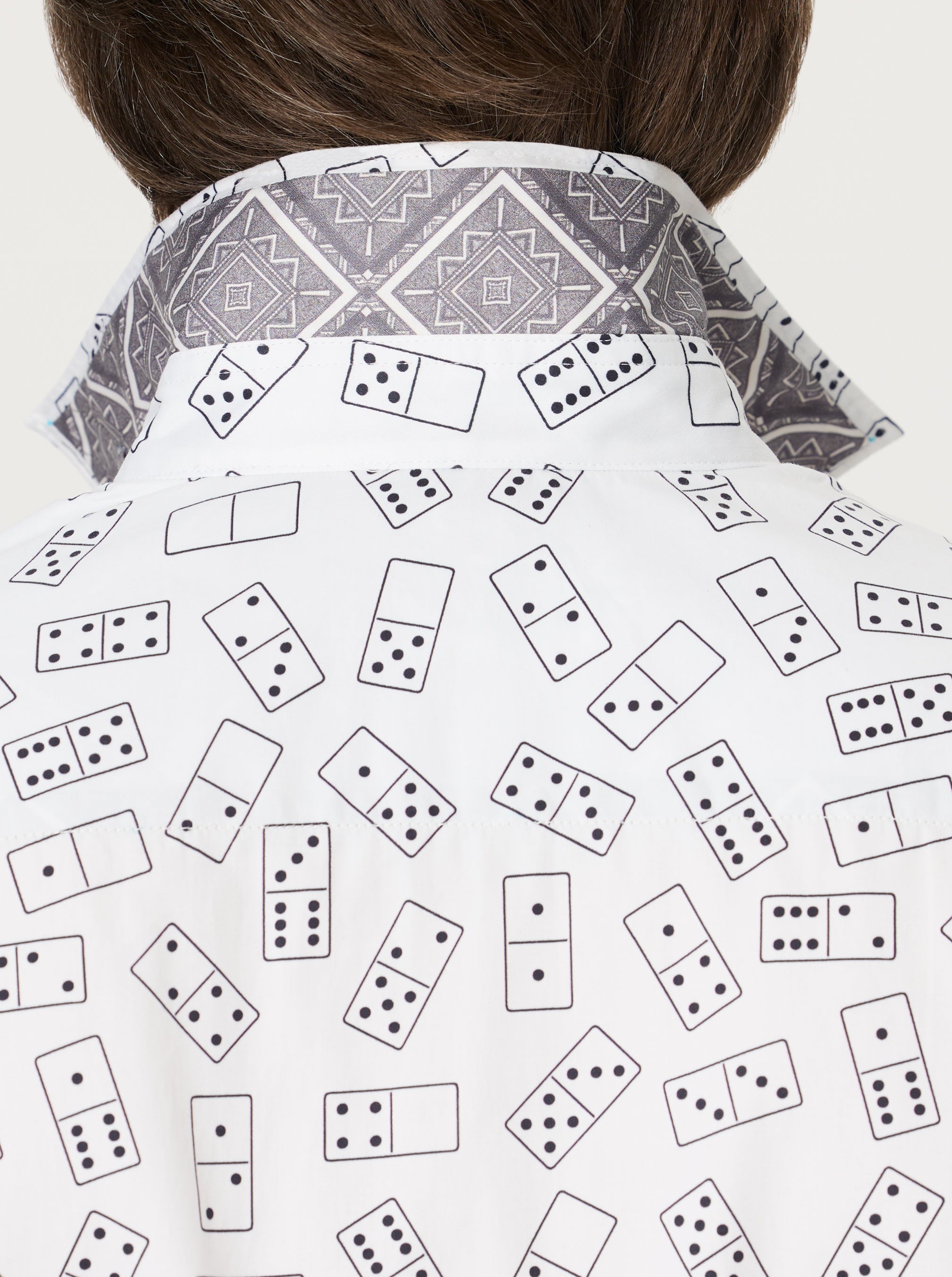 Person wearing a shirt with black and white domino pattern