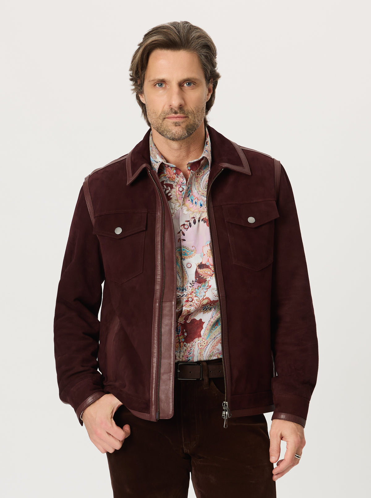 Man wearing a BURGUNDY jacket over a patterned shirt on a white background