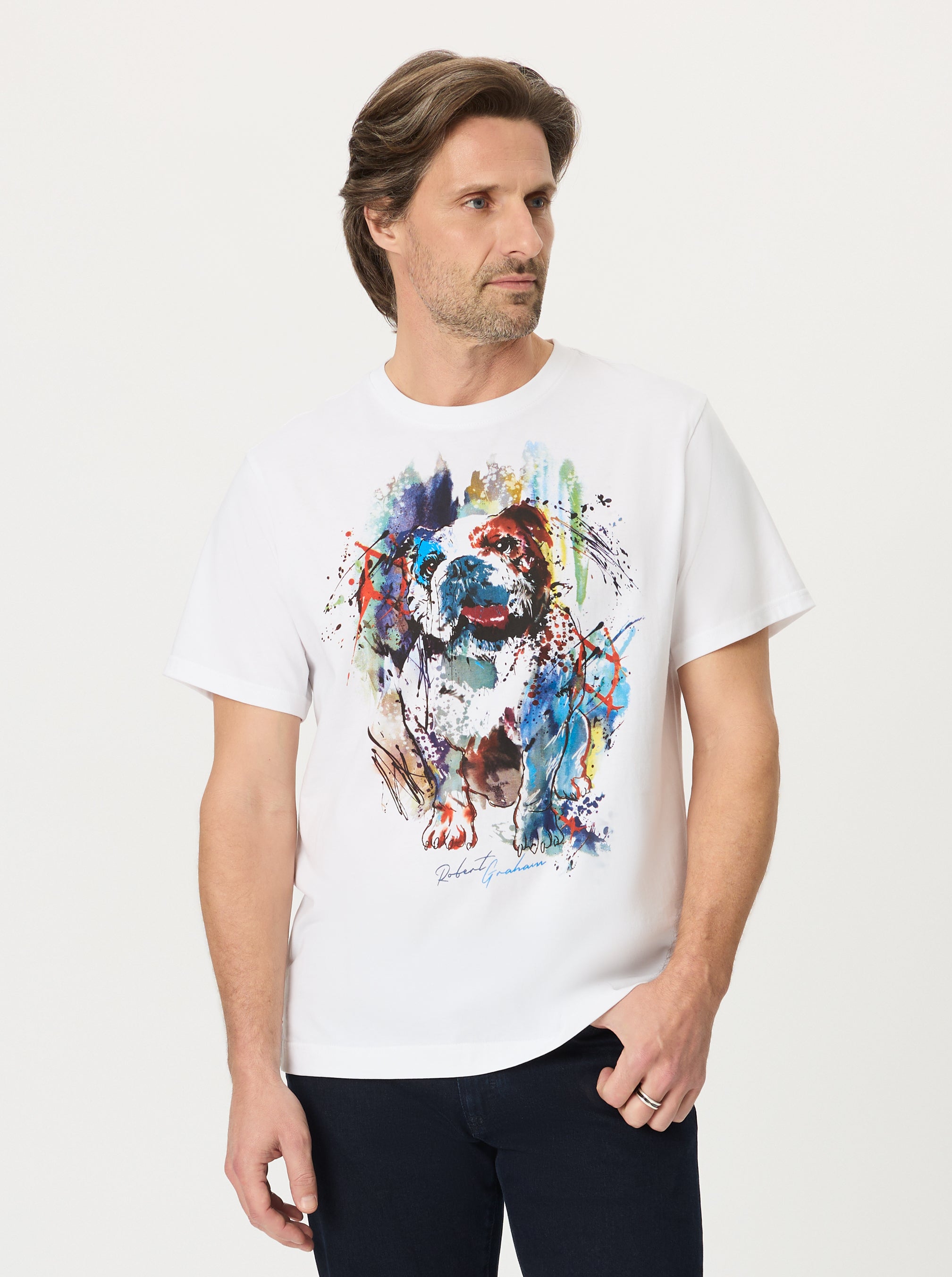Man wearing a white t-shirt with a colorful French bulldog graphic on a plain background
