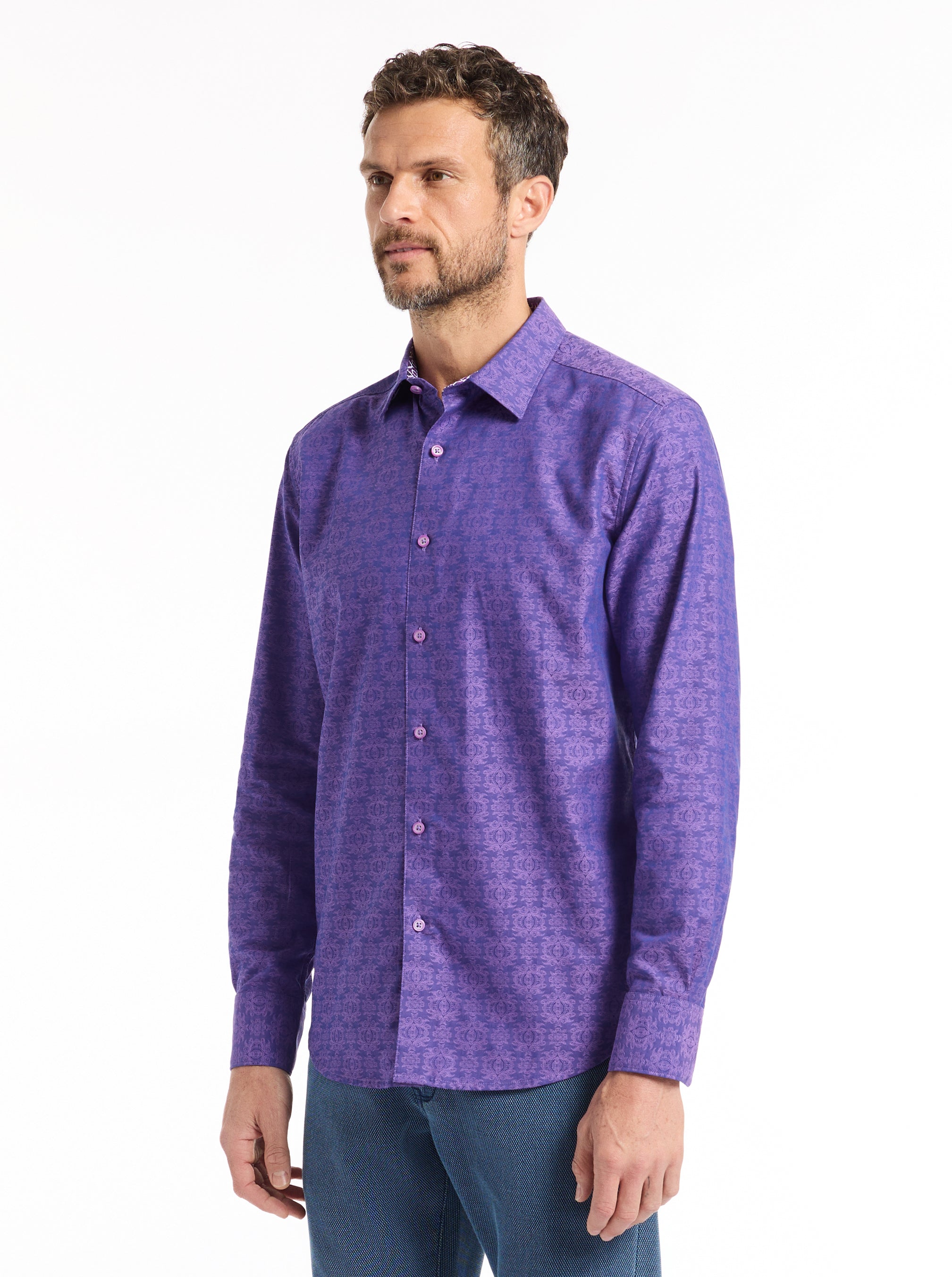 Man wearing a purple patterned shirt on a white background