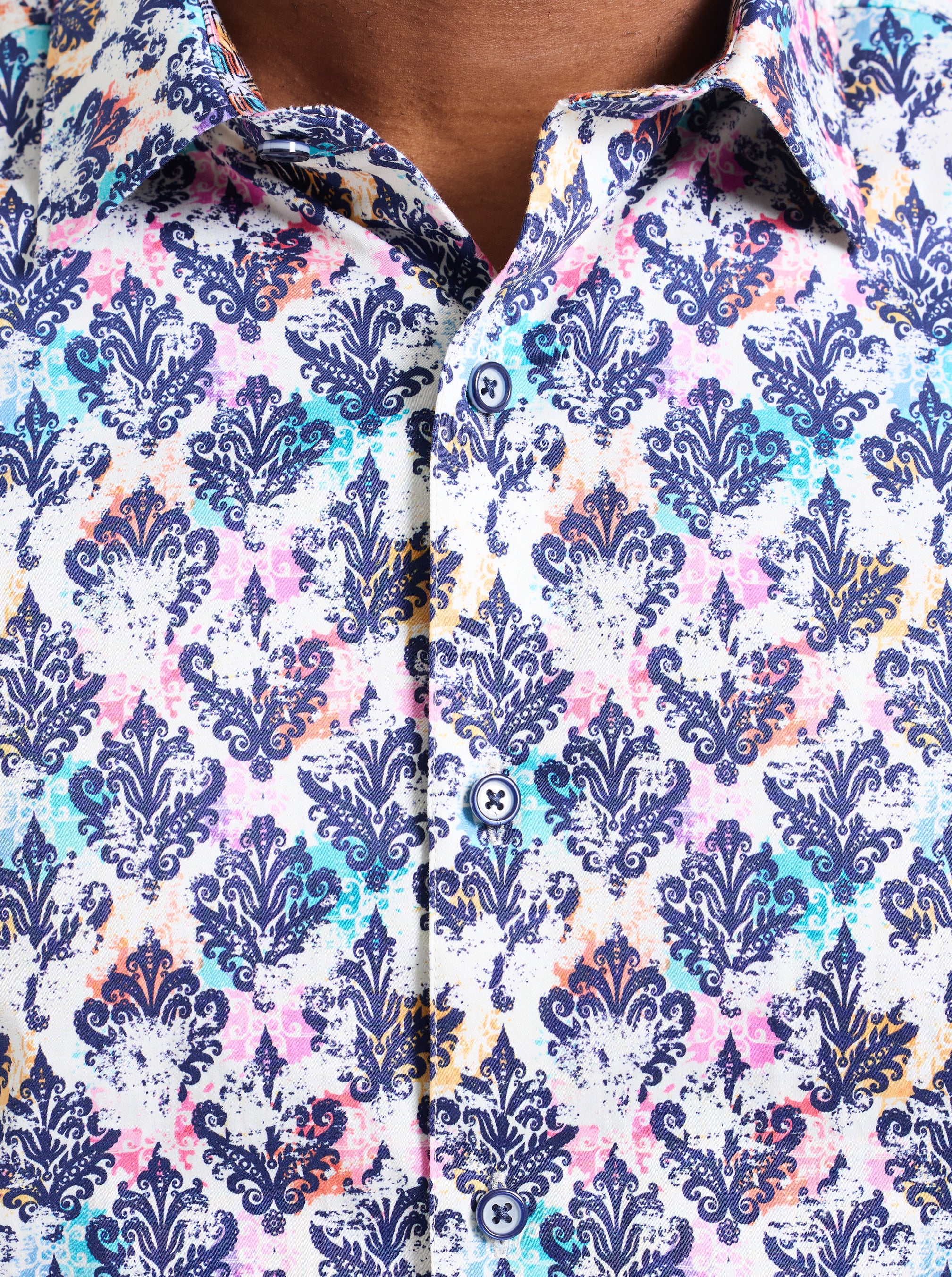 Close-up of a patterned shirt with blue, pink, and white design.