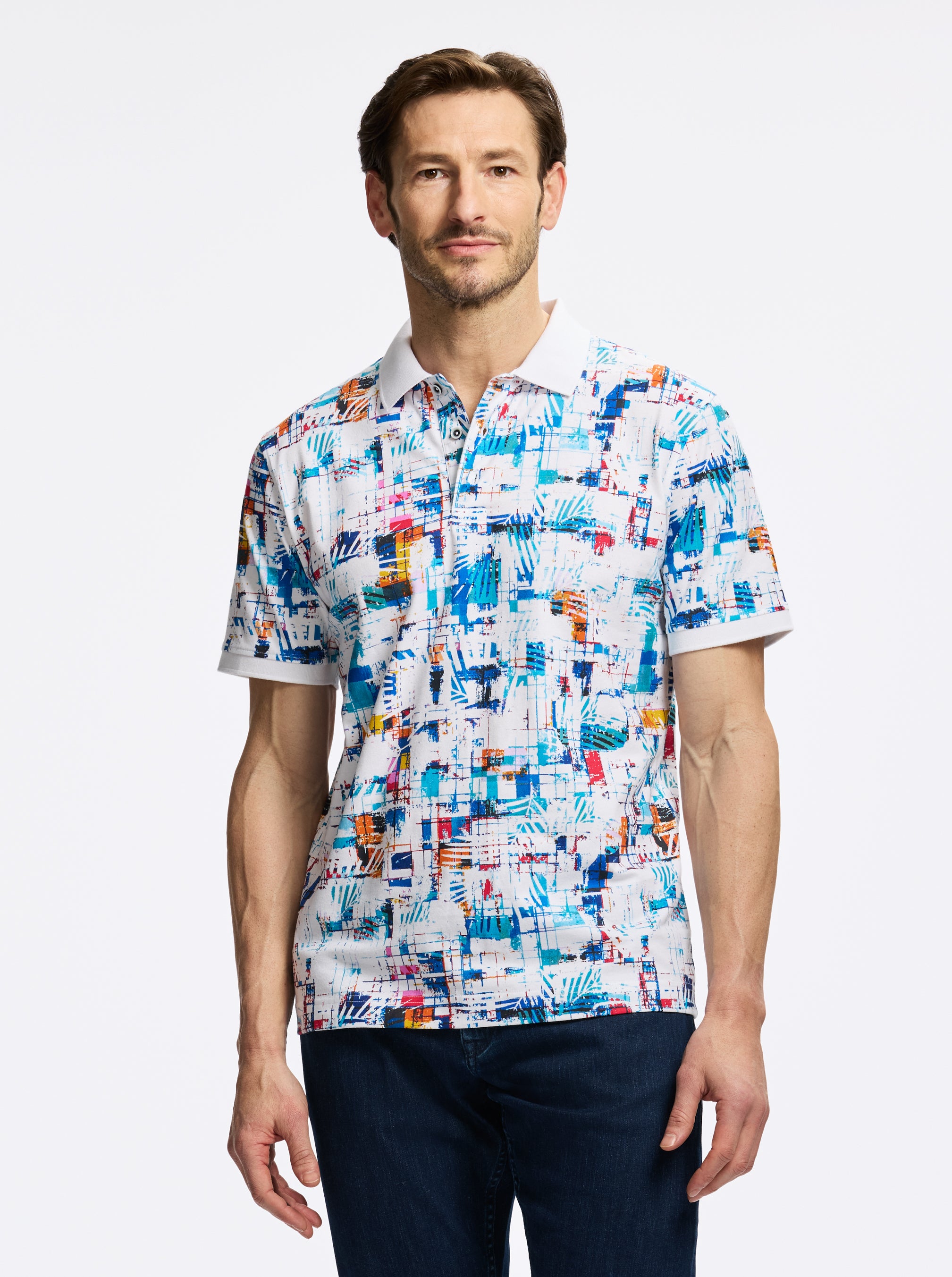 Man wearing a colorful patterned shirt on a white background