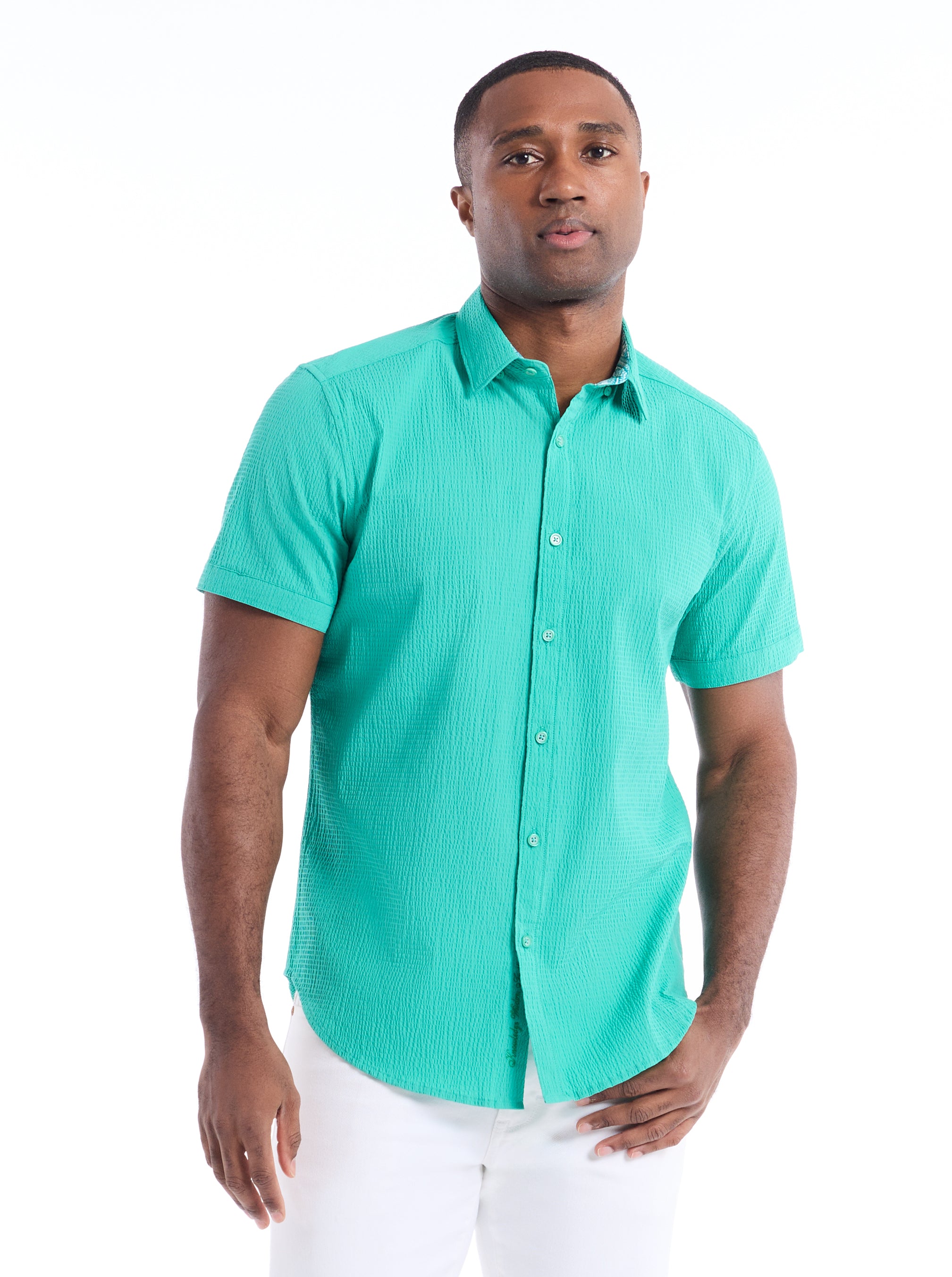 Man wearing a teal short-sleeve shirt on a white background