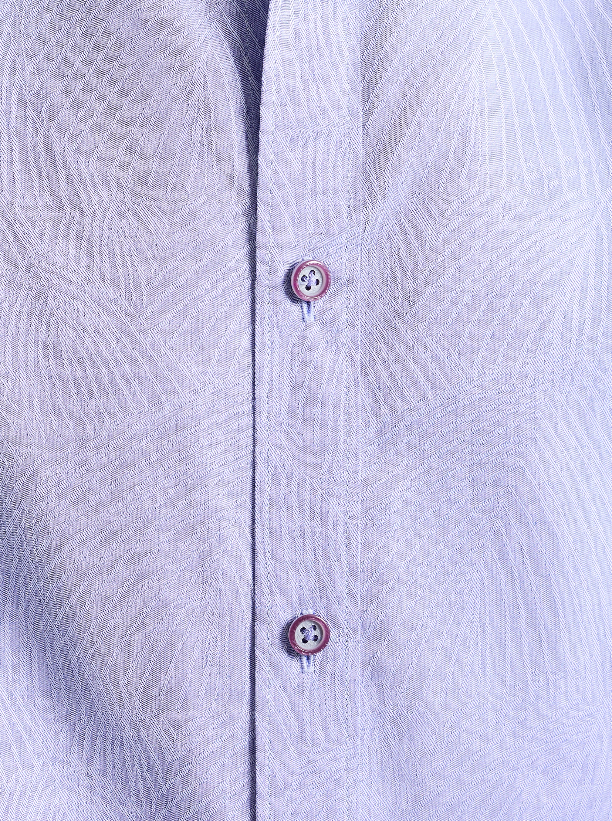 Close-up of a light purple subtle printed shirt with buttons.