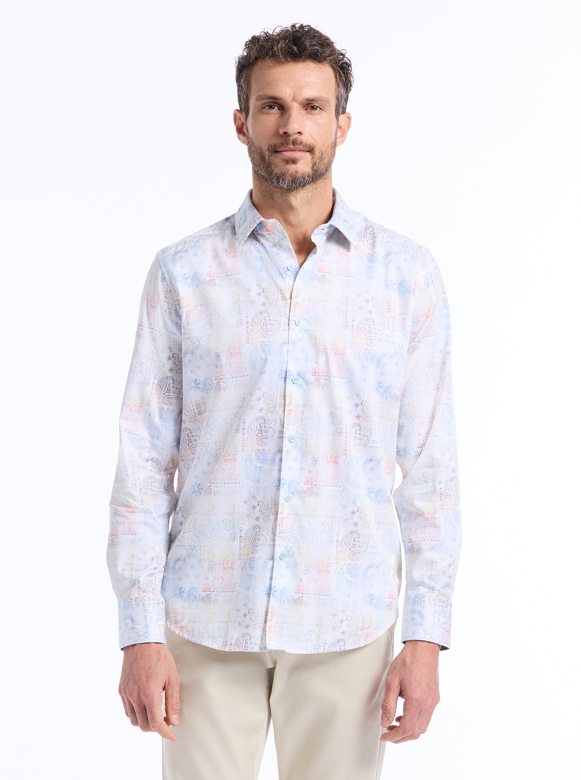 Man wearing a multicolored patterned shirt on a white background