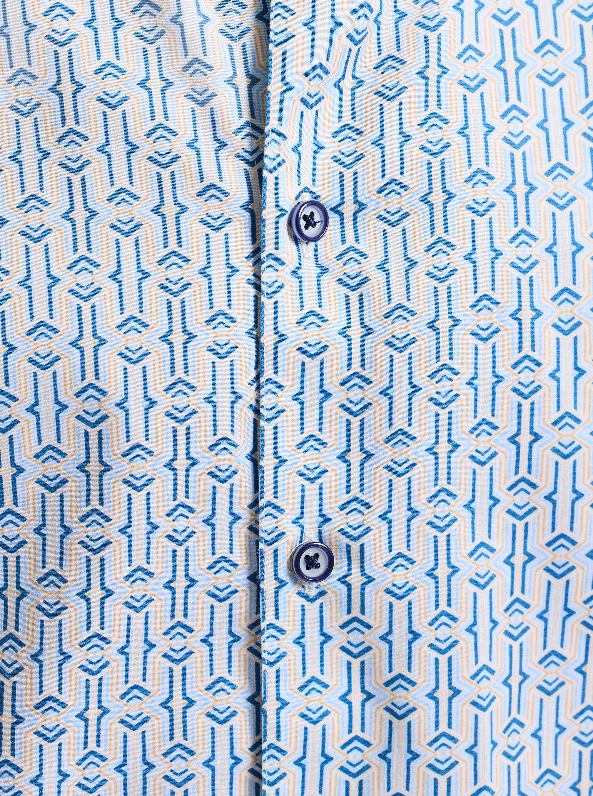 Close-up of a shirt with a blue geometric pattern and buttons.