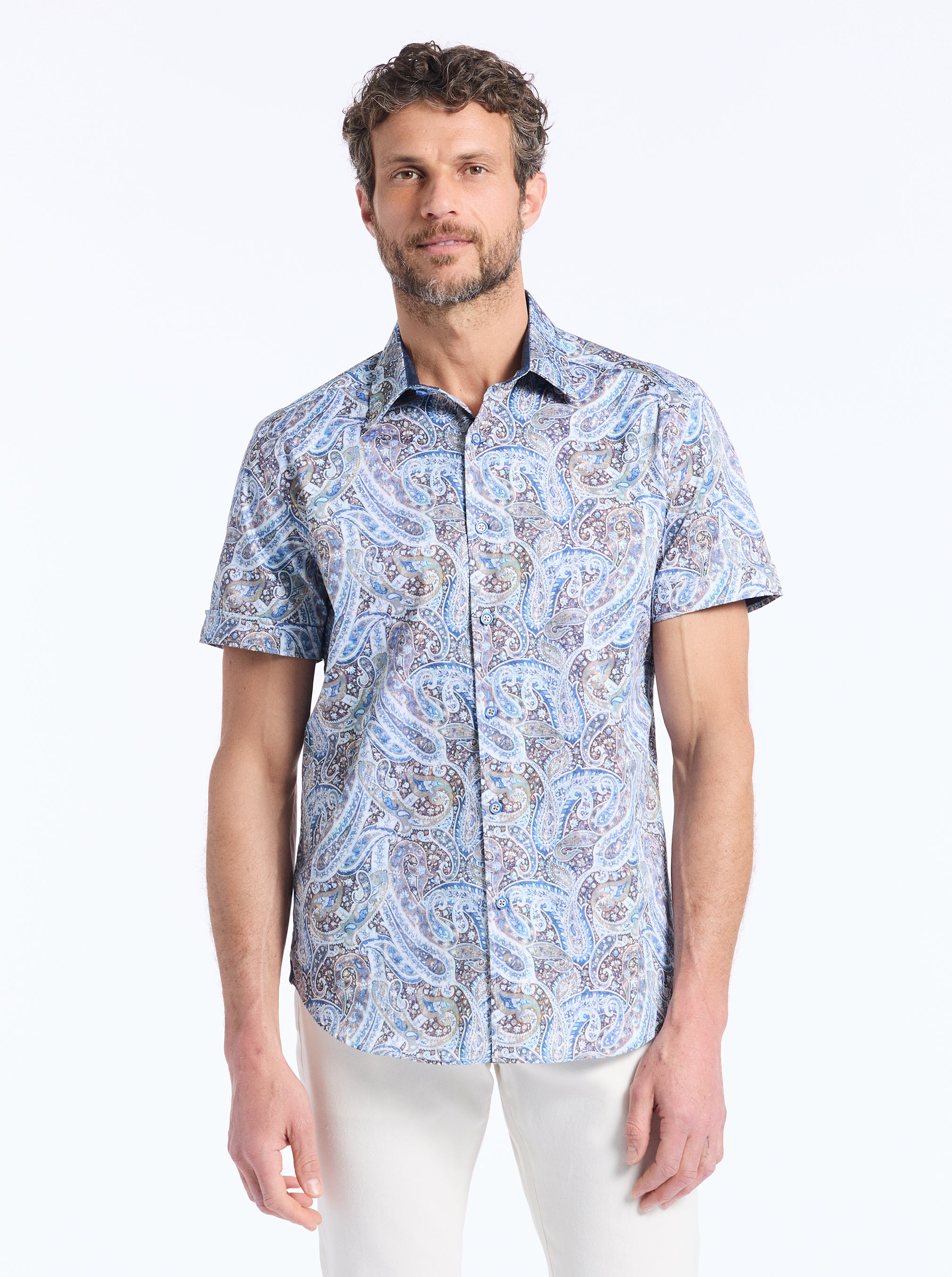 Man wearing a blue patterned shirt on a white background