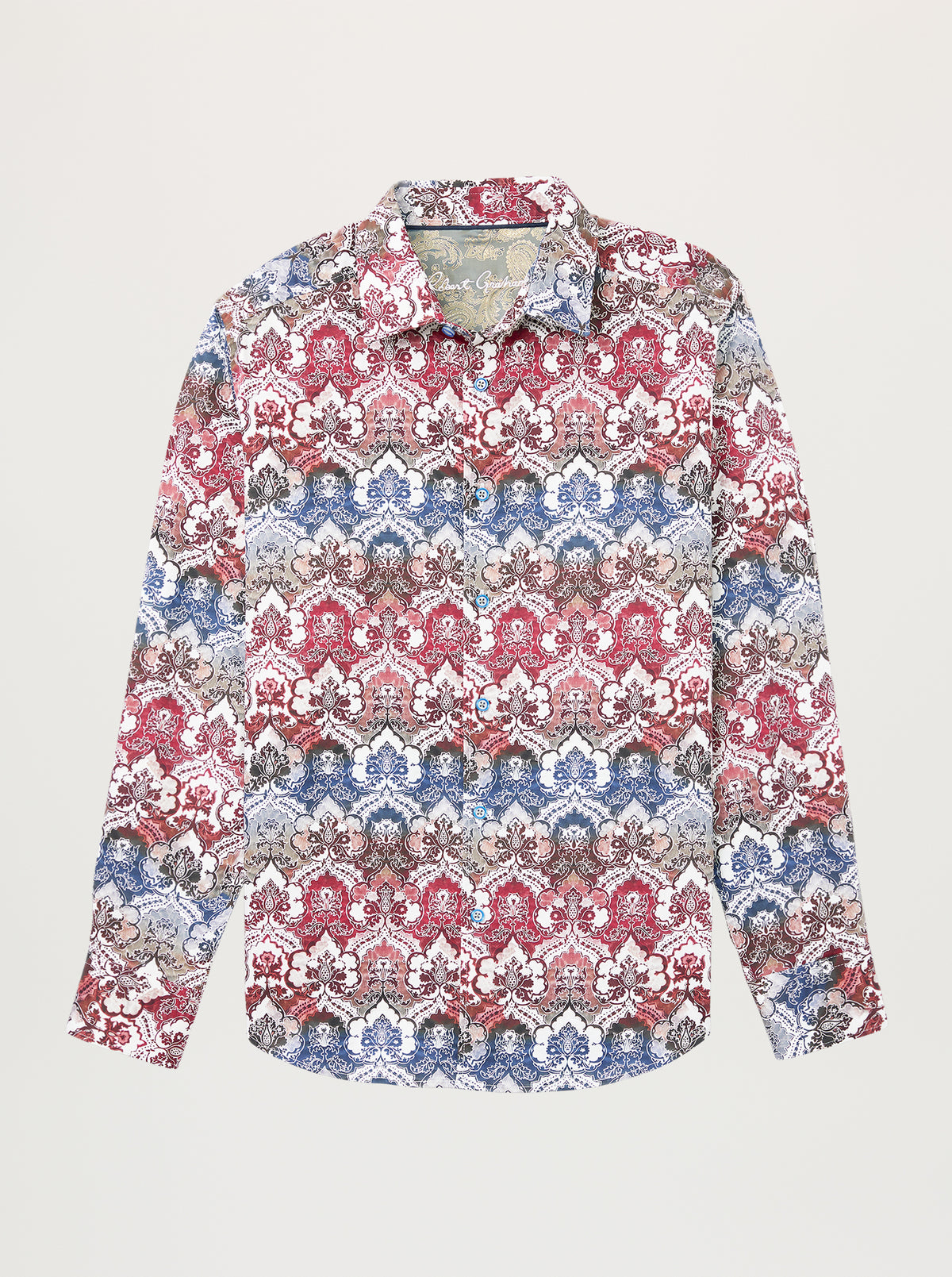 A long-sleeve button-up shirt with an intricate, repeating damask-style pattern in red, blue, beige, and gray, displayed flat against a light gray background.