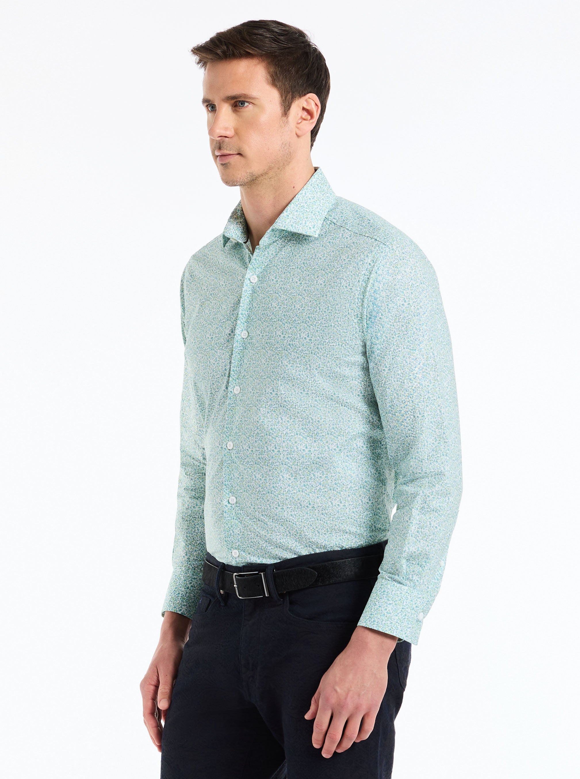 Man wearing a light blue patterned shirt on a white background