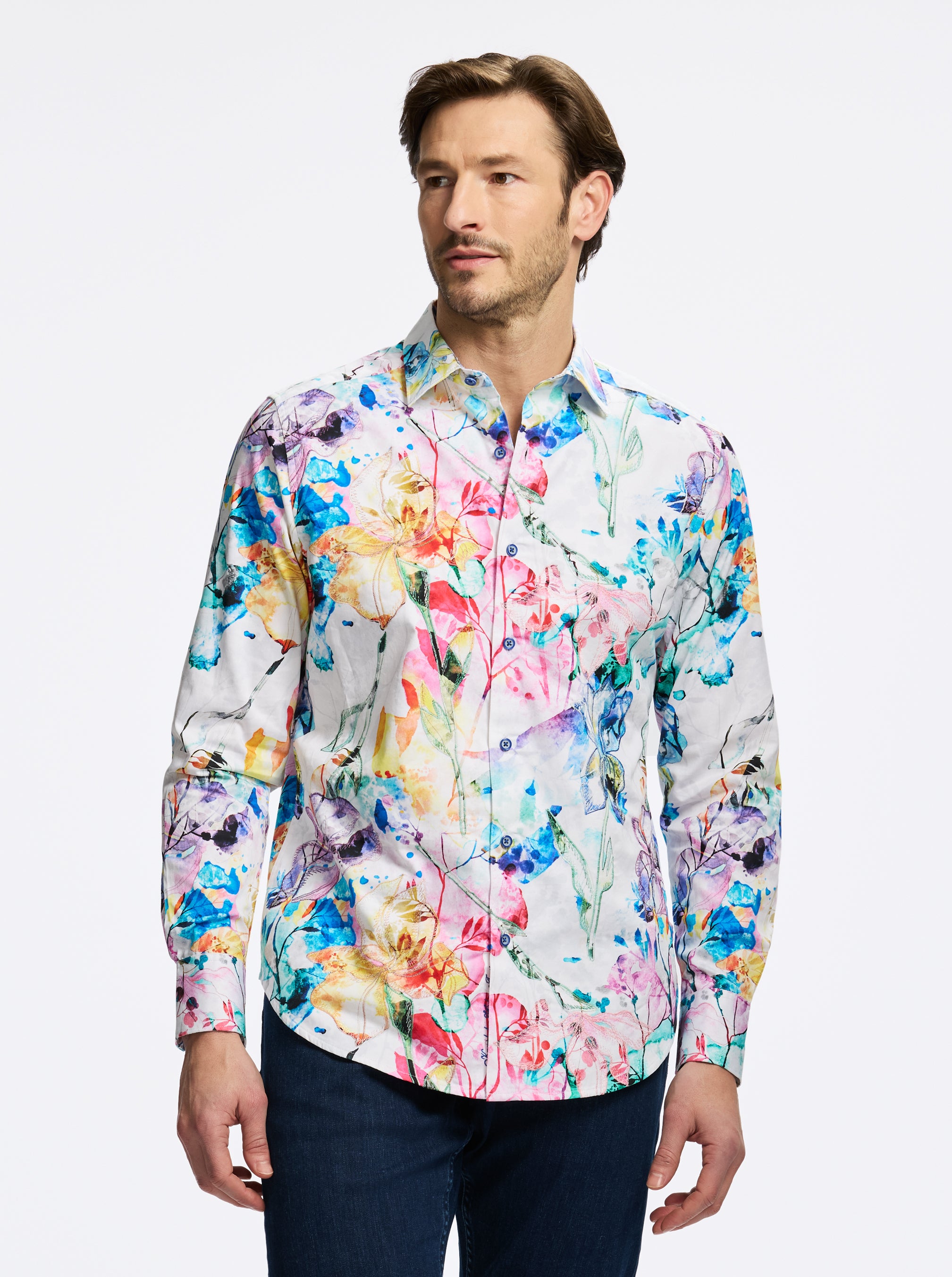 Man wearing a colorful floral shirt against a white background