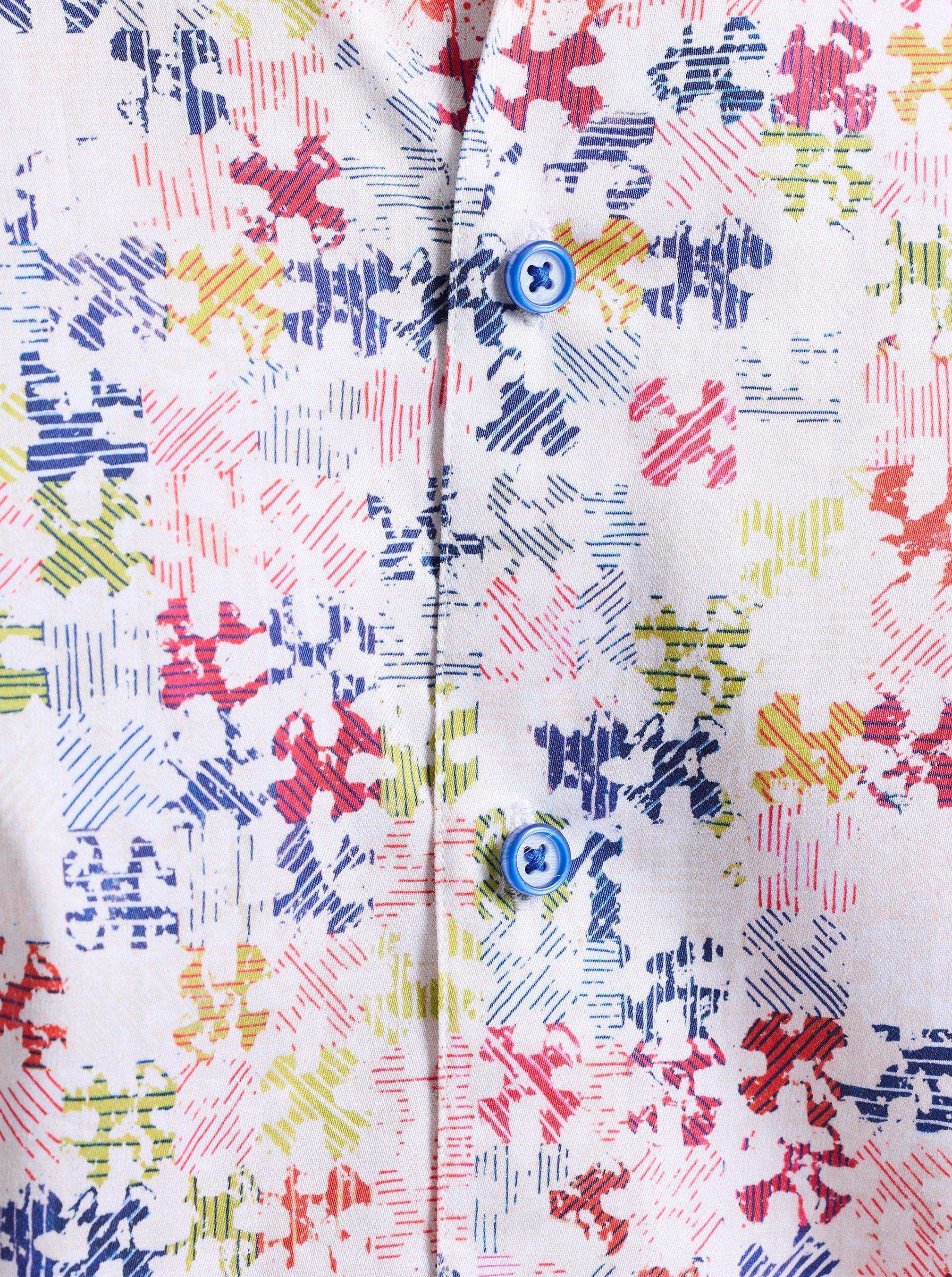 Close-up of a colorful puzzle patterned garment with buttons.