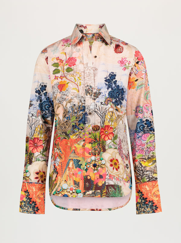 Colorful floral and animal patterned shirt on a white background